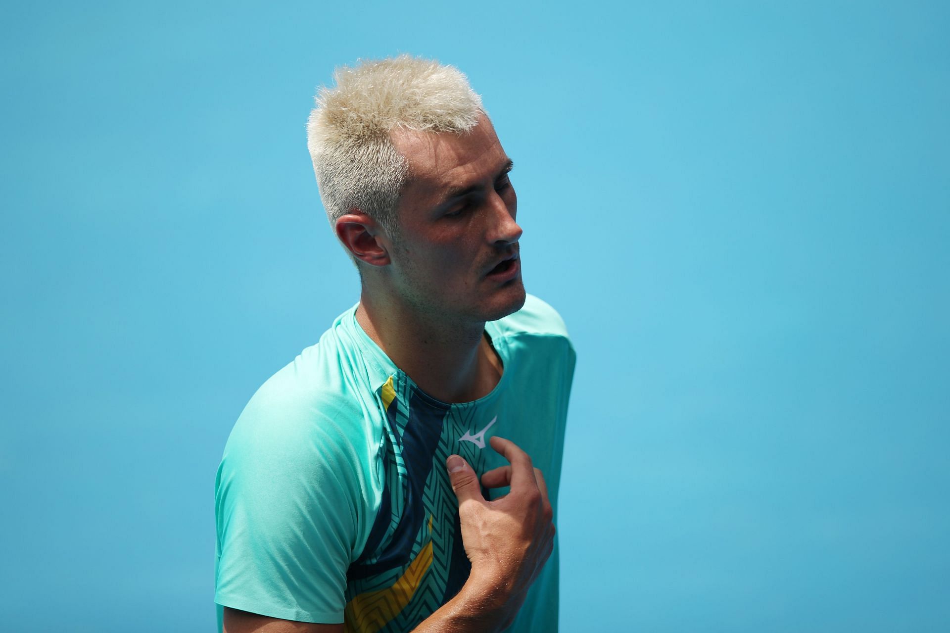 Bernard Tomic reacts in his match against Roman Safiullin at the 2022 AO qualifying: Day 2