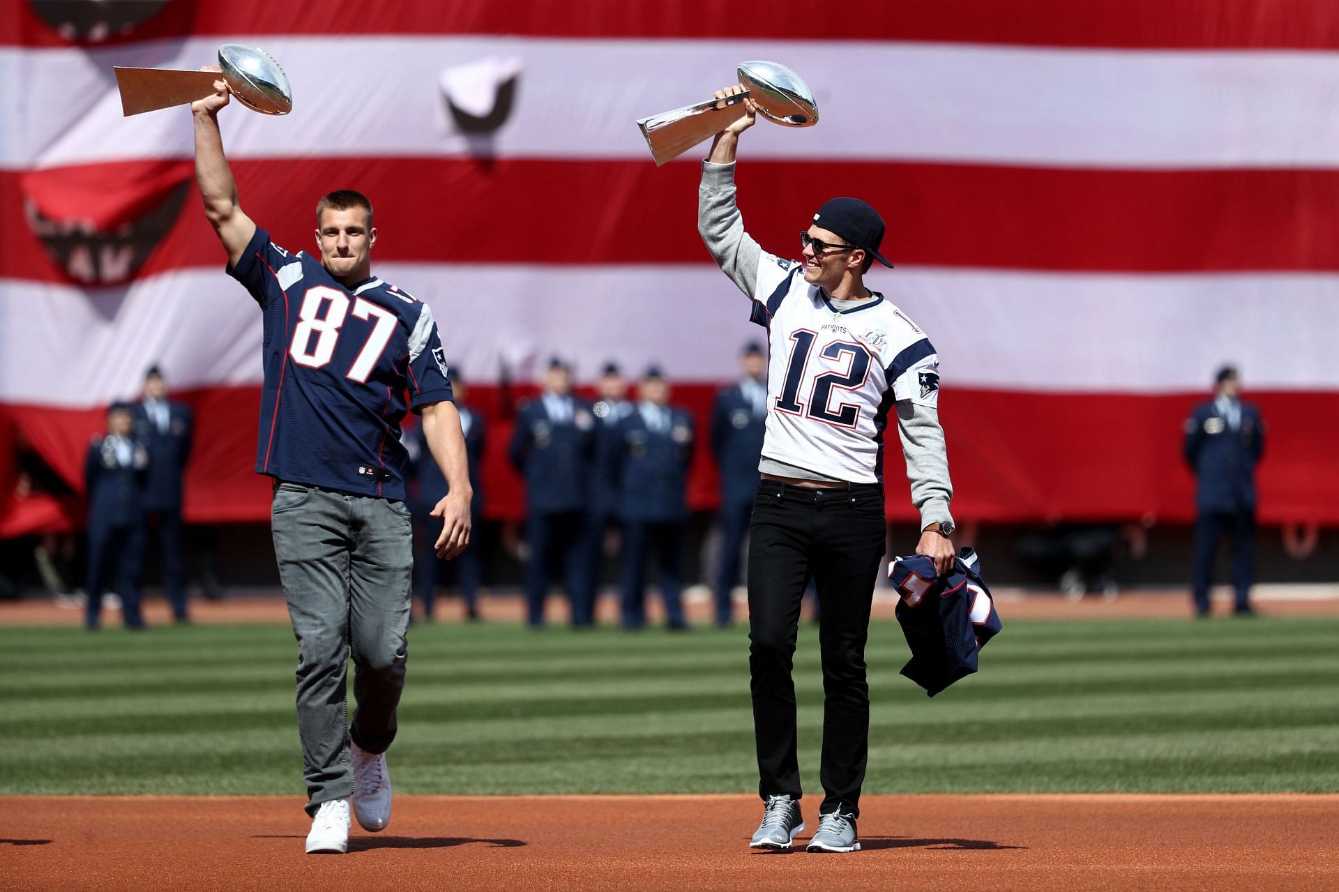 The teammates holding Lombardi Trophies at Fenway Park with the Patriots