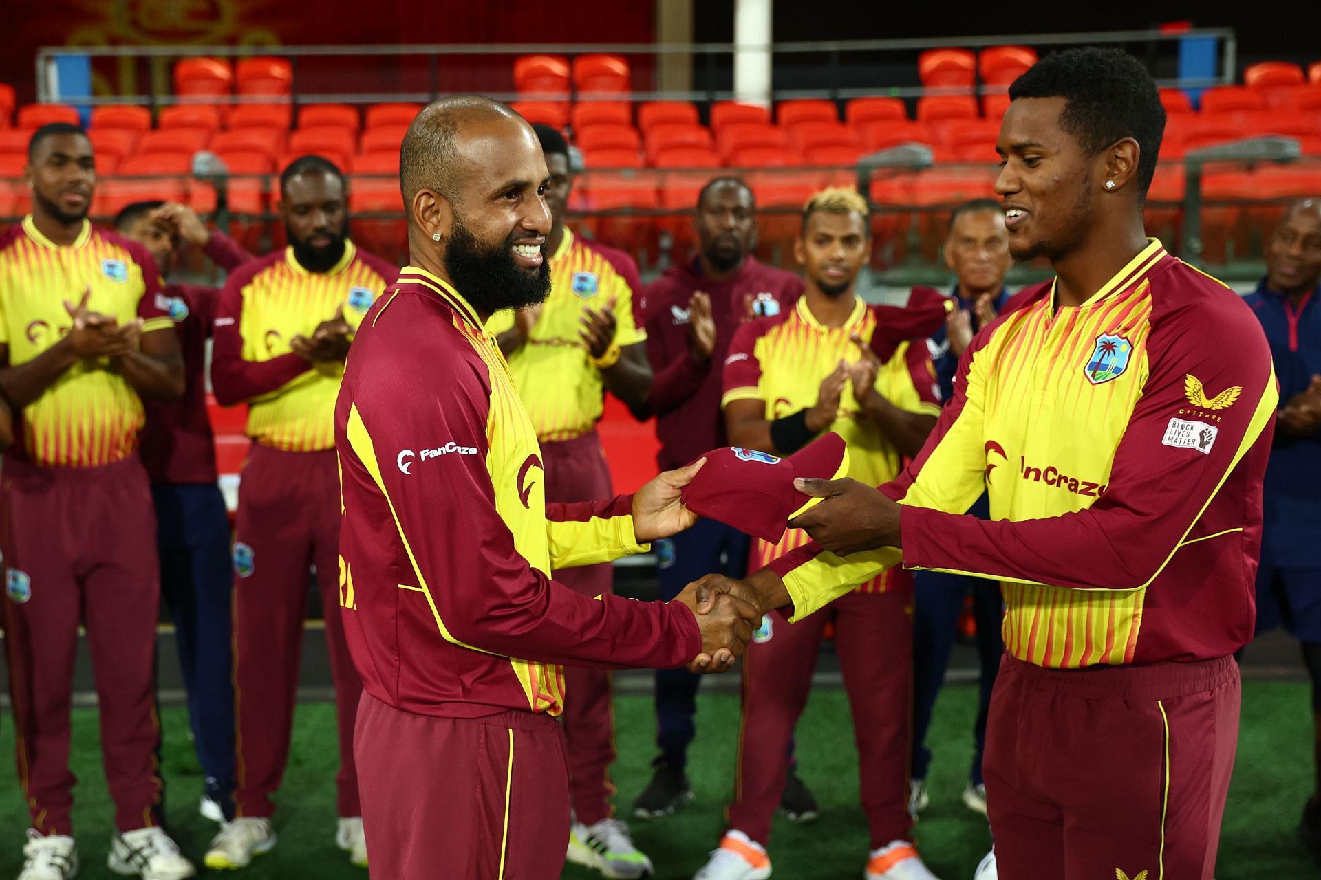 Cariah (L) receiving West Indies cap from Akeal Hosein