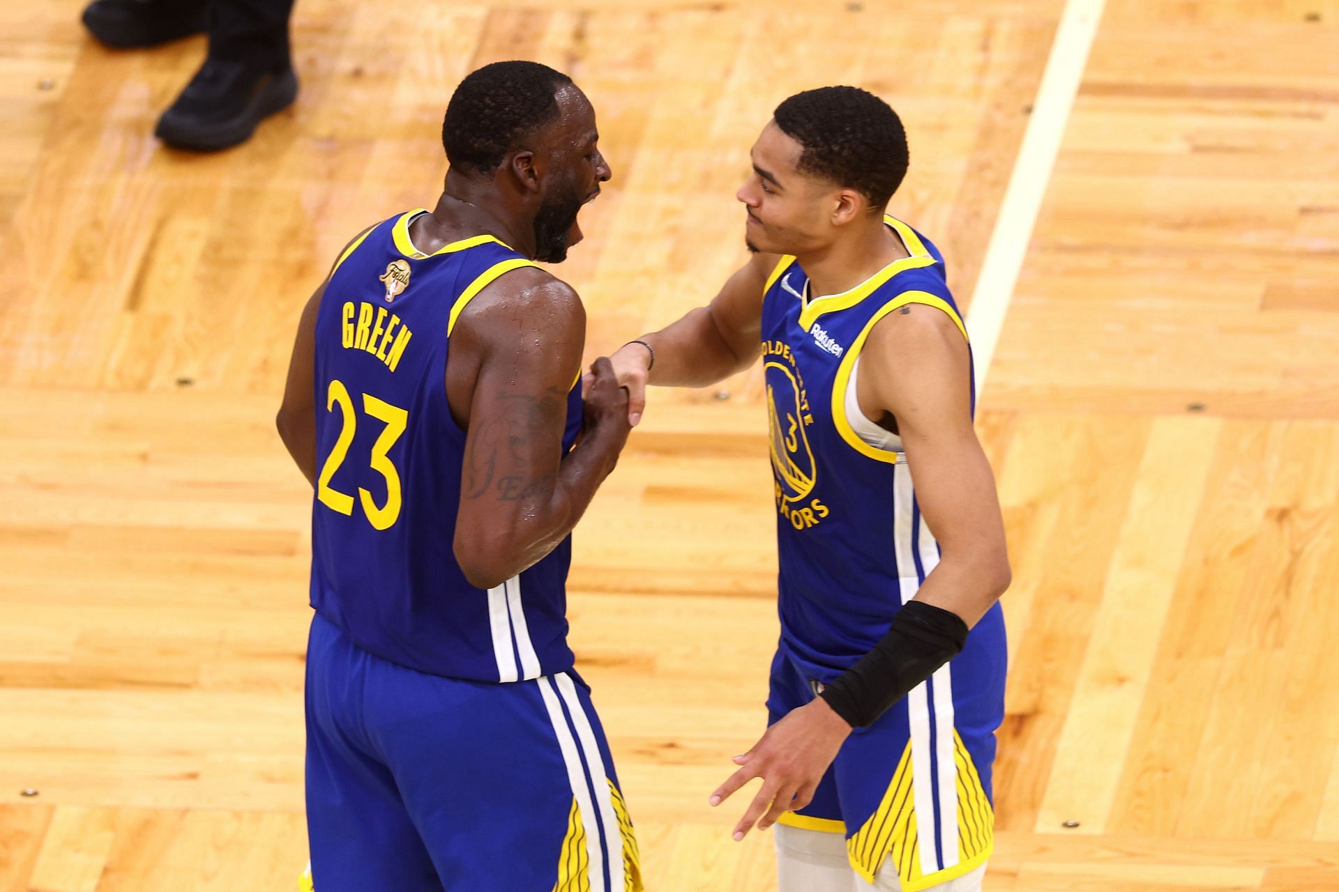 Warriors teammates Draymond Green, left, and Jordan Poole at the 2022 NBA Finals, Game 6