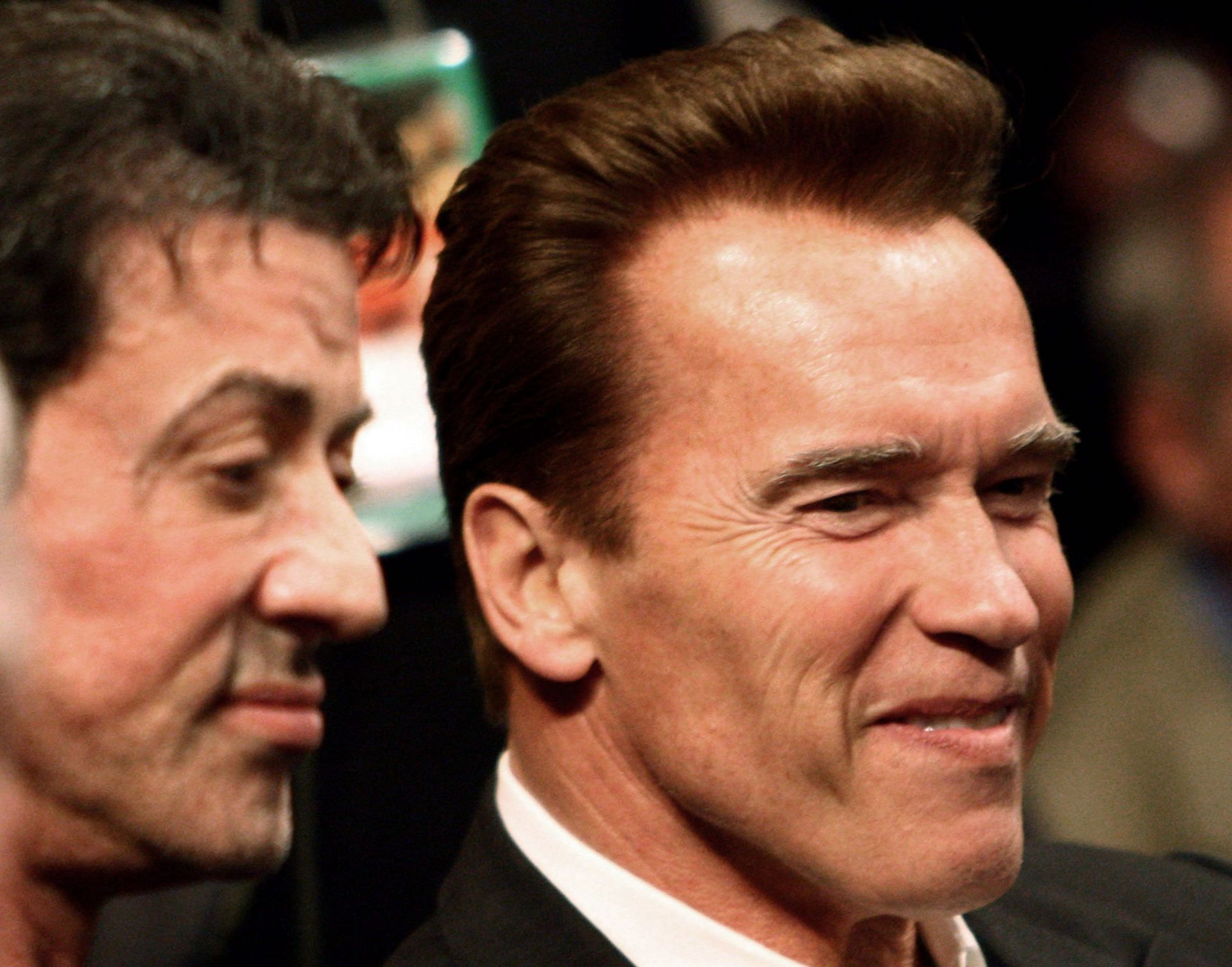 Arnold Schwarzenegger and Sylvester Stallone in 2009 (Image via Getty Images/Donald Miralle)