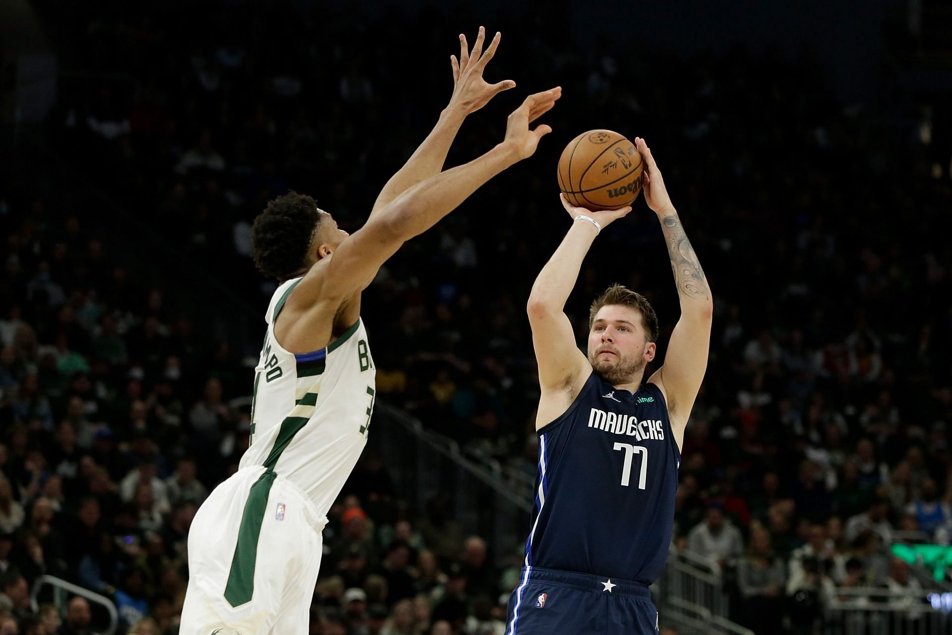 Dallas Mavericks supertstar guard Luka Doncic shooting over Milwaukee Bucks superstar forward Giannis Antetokounmpo