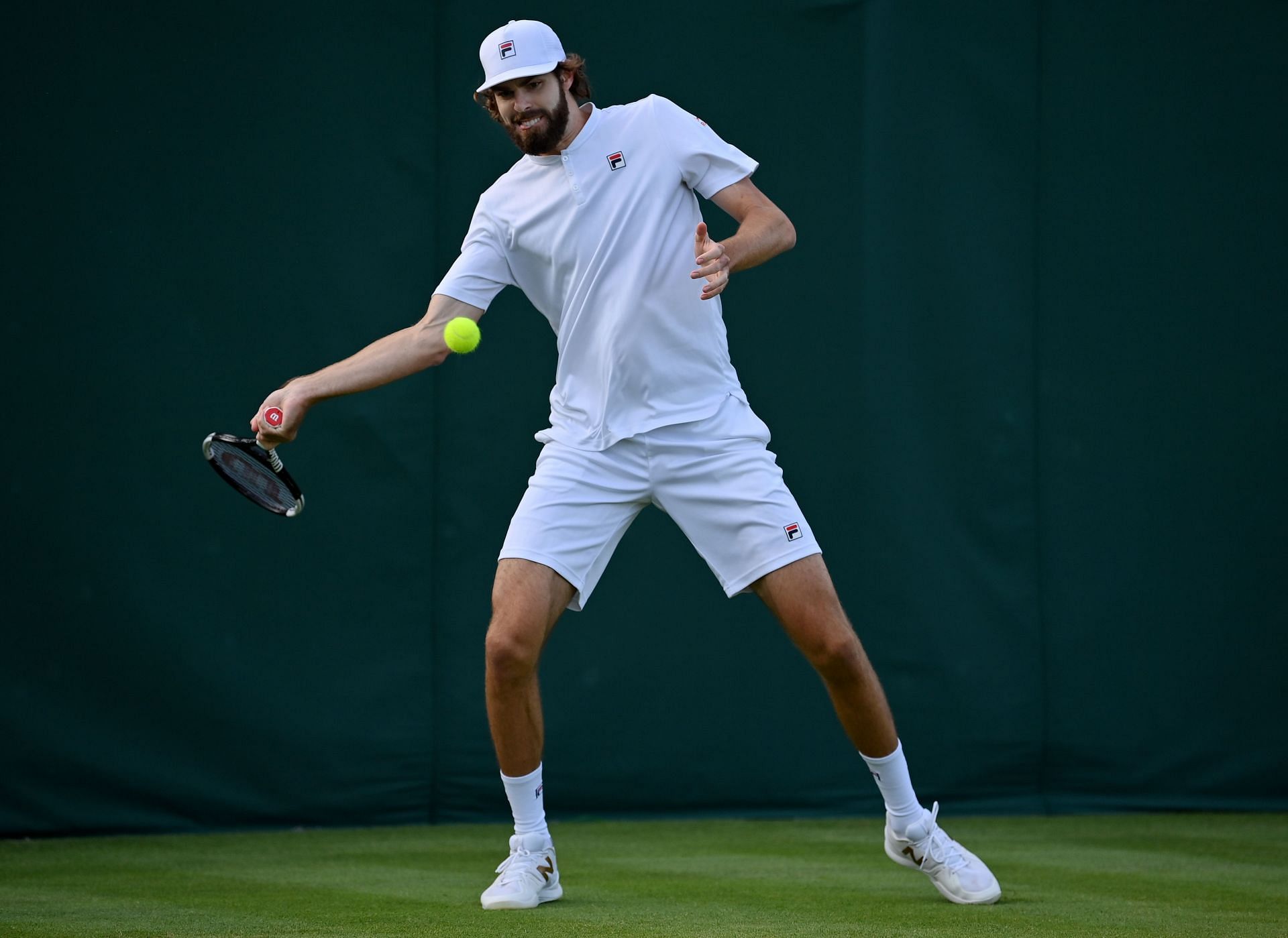 Reilly Opelka plays a forehand against Carlos Taberner on Day One: The Championships - Wimbledon 2022