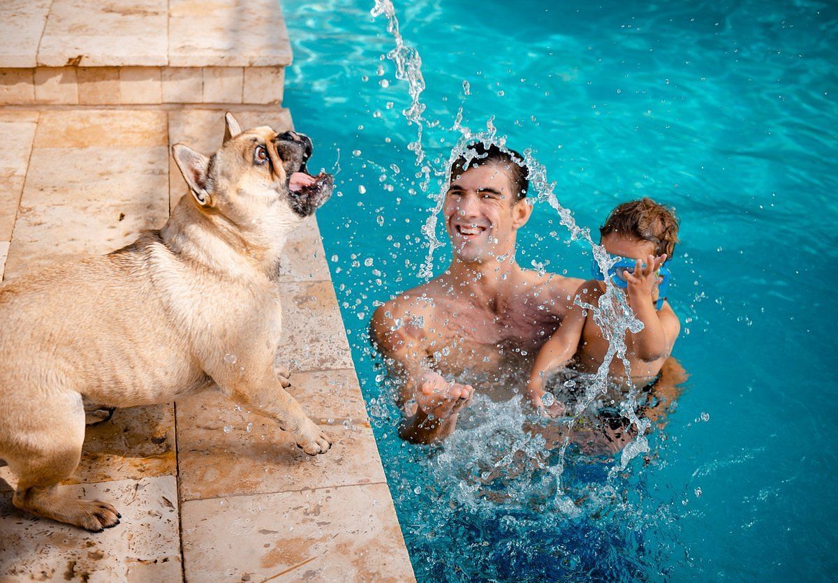 The swimmer and his dog, Juno (Image via Celebrity Pets)