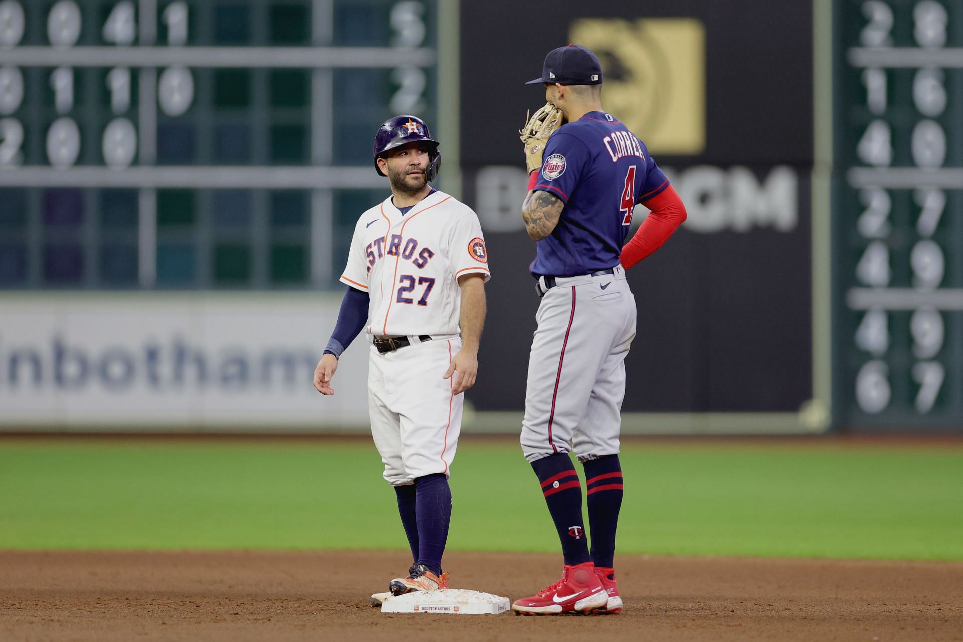 Jose Altuve speaks with Carlos Correa during the fifth inning during a game at Minute Maid Park