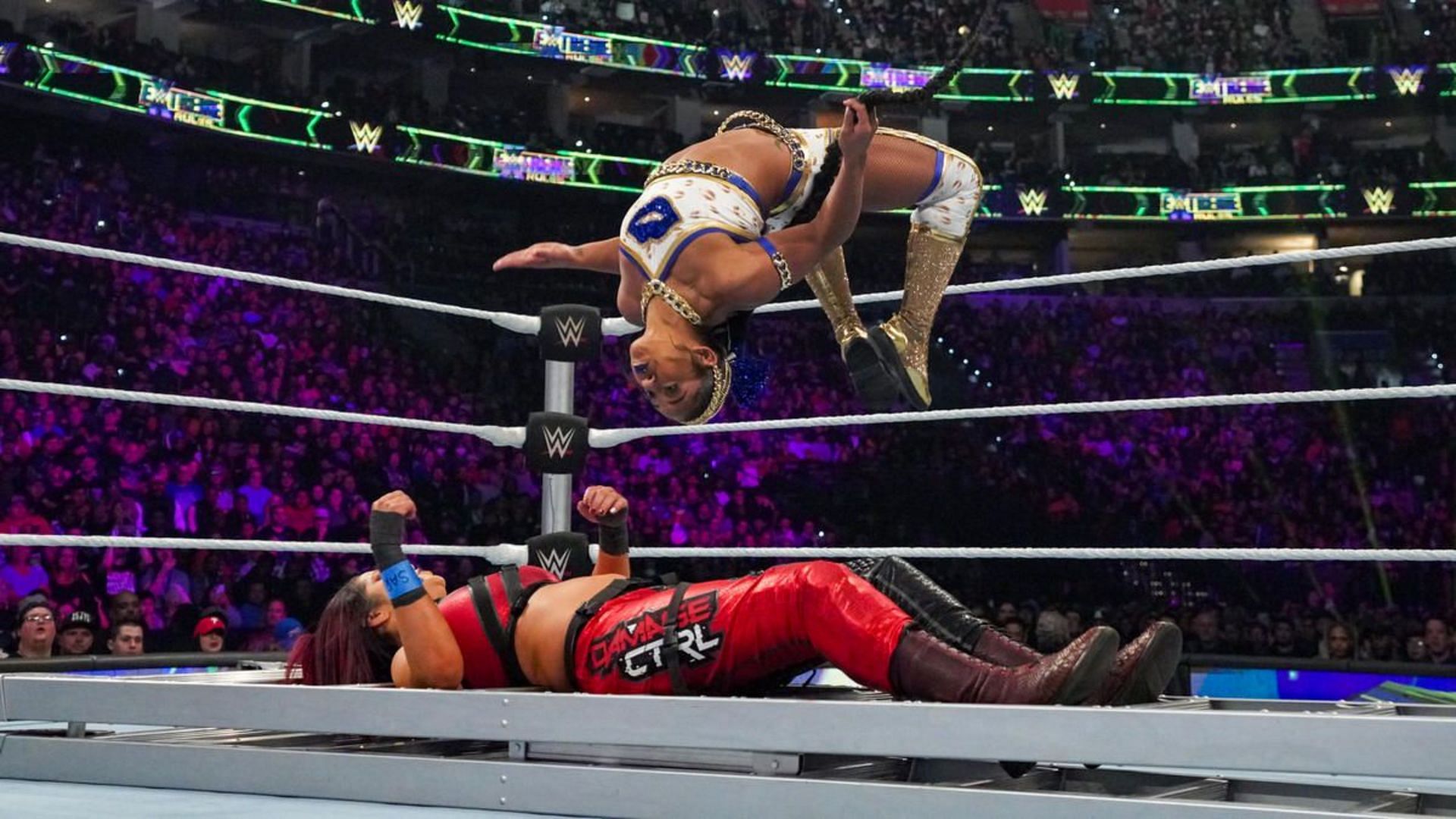 Bianca Belair delivering a Moonsault to Bayley on a ladder (Source: WWE.com)