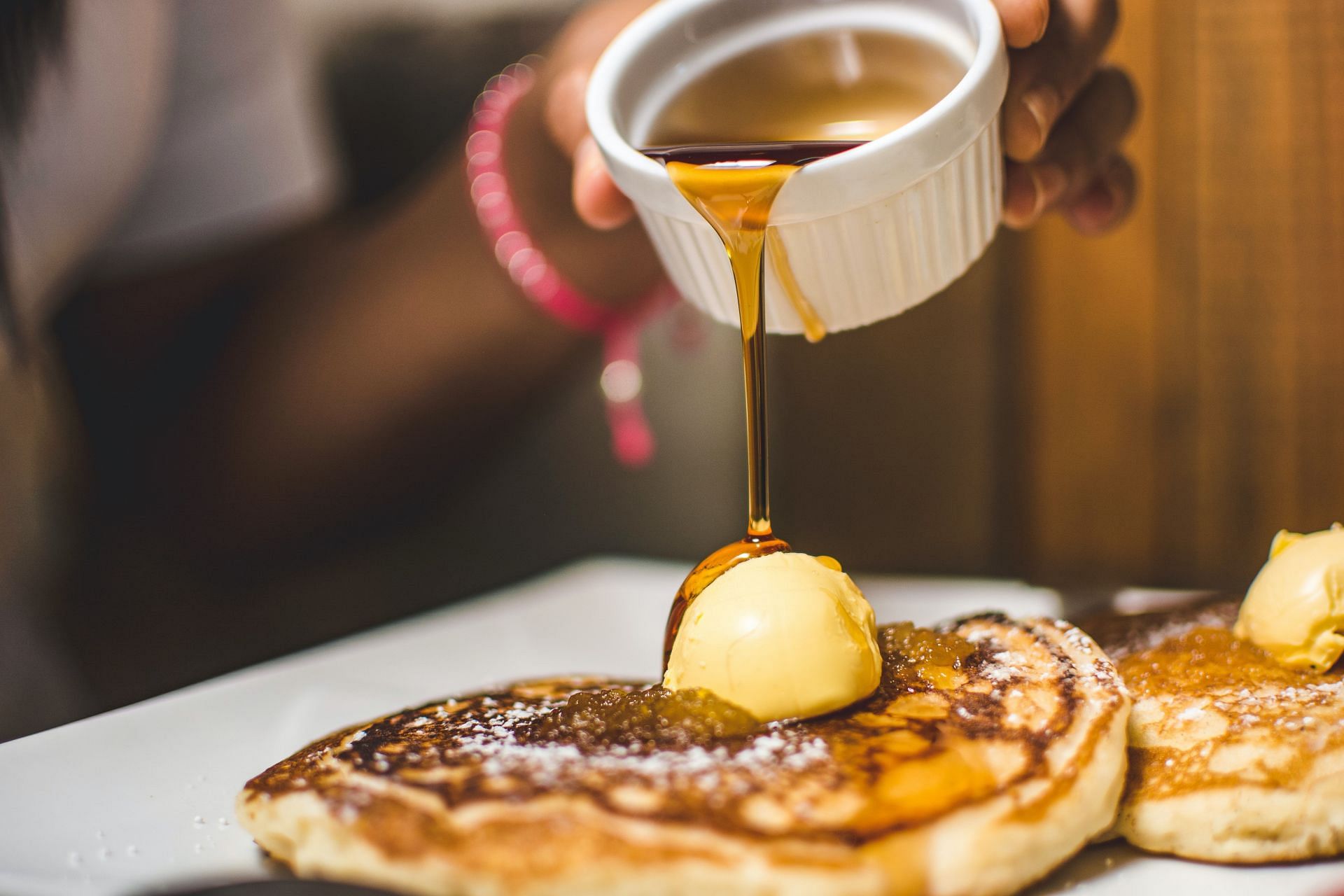 Honey makes pancakes tastier (Image via Unsplash/Kobby Mendez)