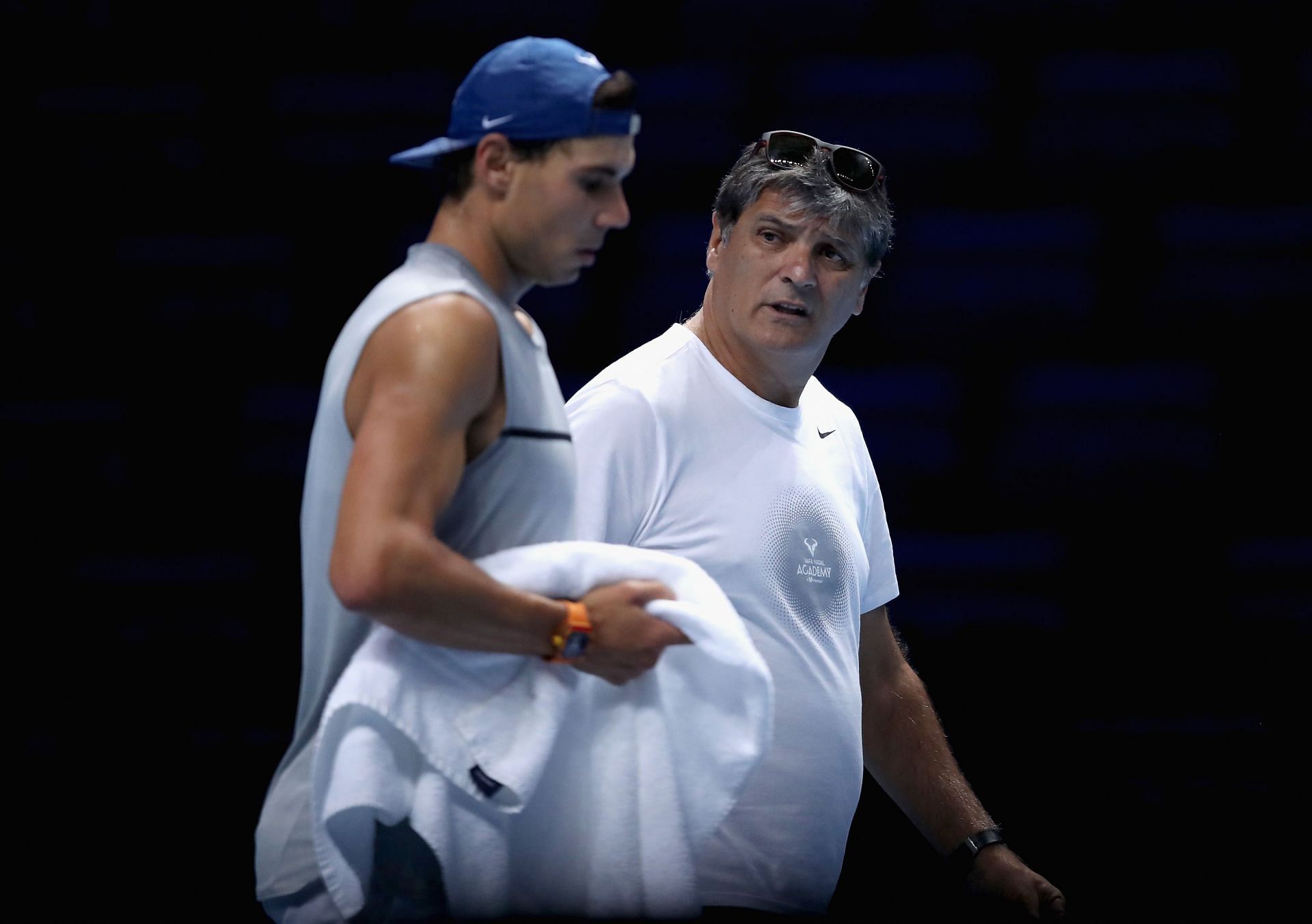 Rafael Nadal (L) and Toni Nadal speak during a training session.