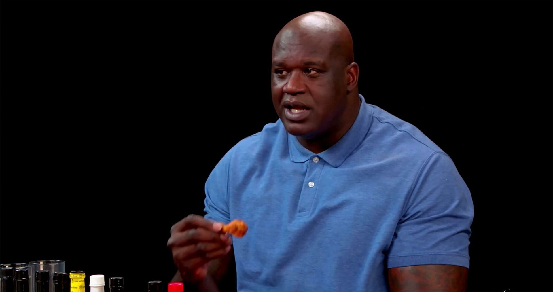 O'Neal holds up a chicken wing [Source: MobileSyrup]