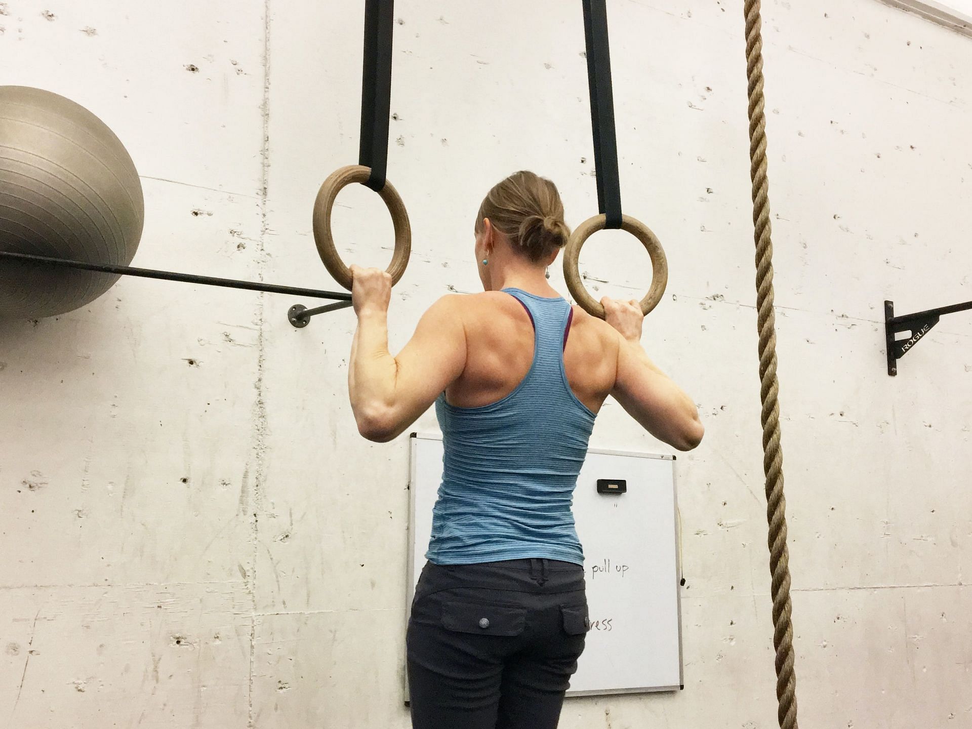 Dead hang is an excellent exercise that involves just hanging from a pull-up bar. (Image via Unsplash/ Gmb Fitness)