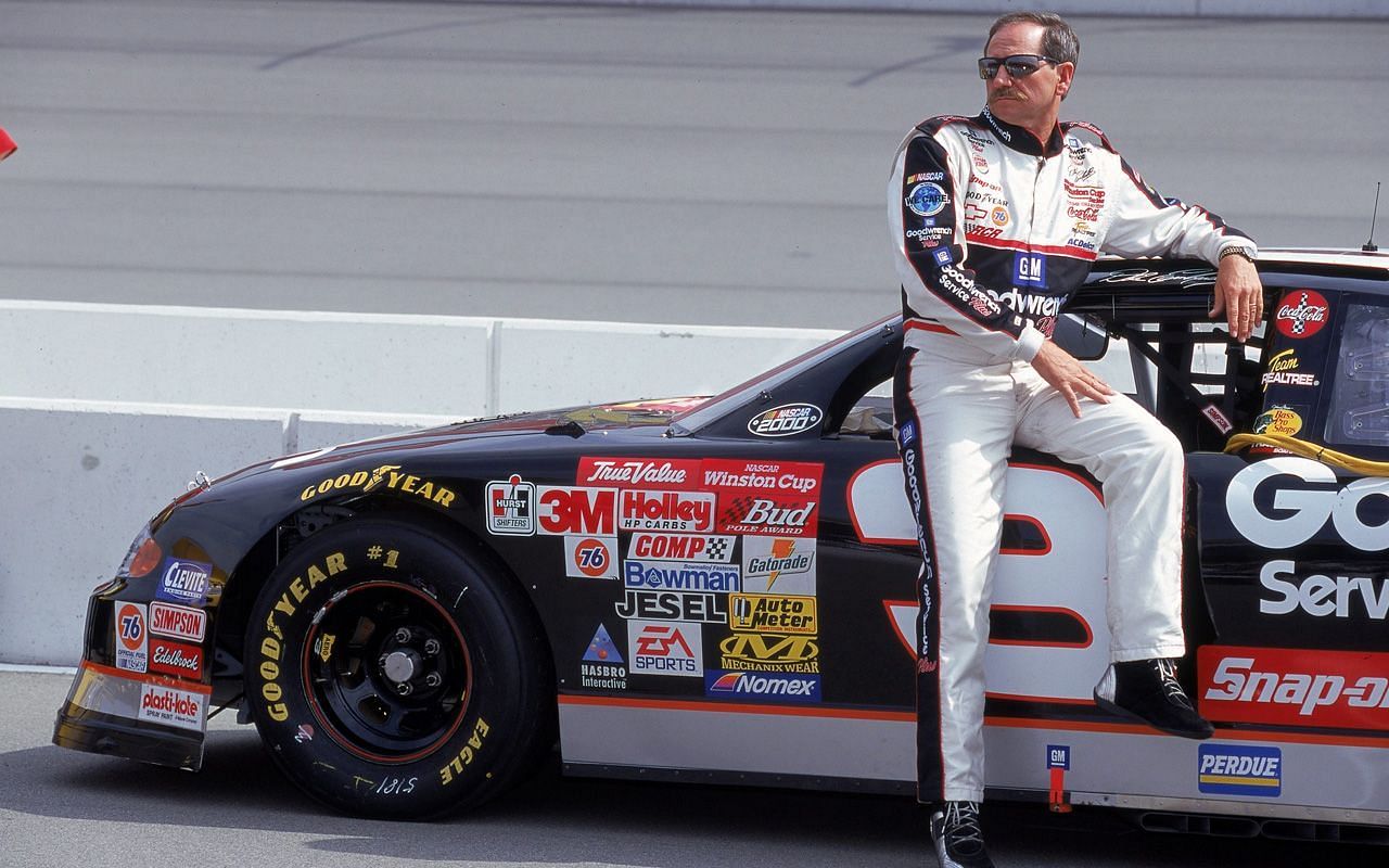 Dale Earnhardt leans on his black #3 Goodwrench Chevrolet, a car and paint scheme made popular by the late driver all over the world.