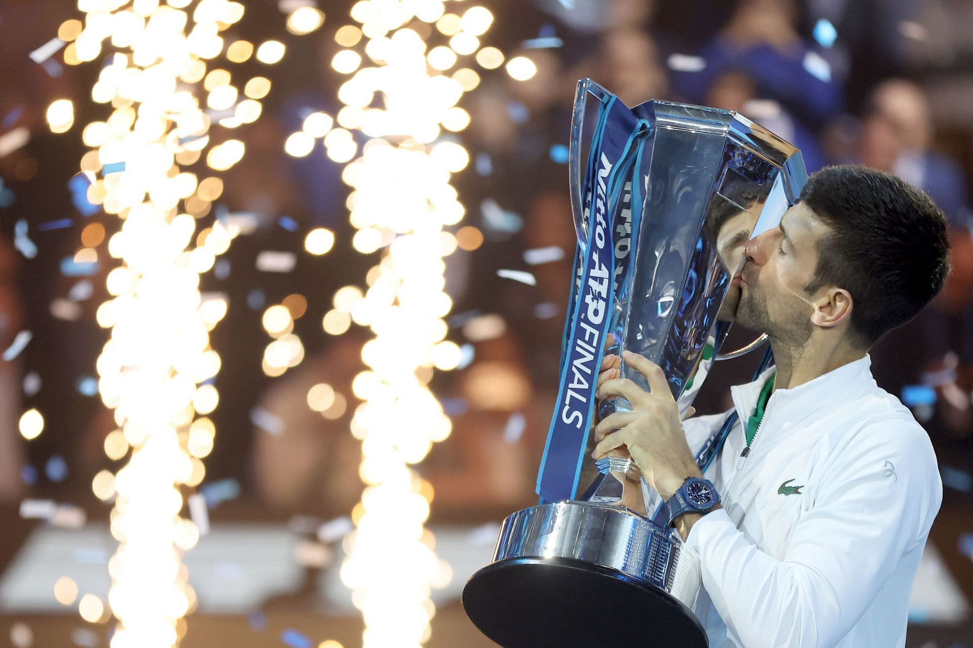 Novak Djokovic kisses his sixth ATP Finals trophy.