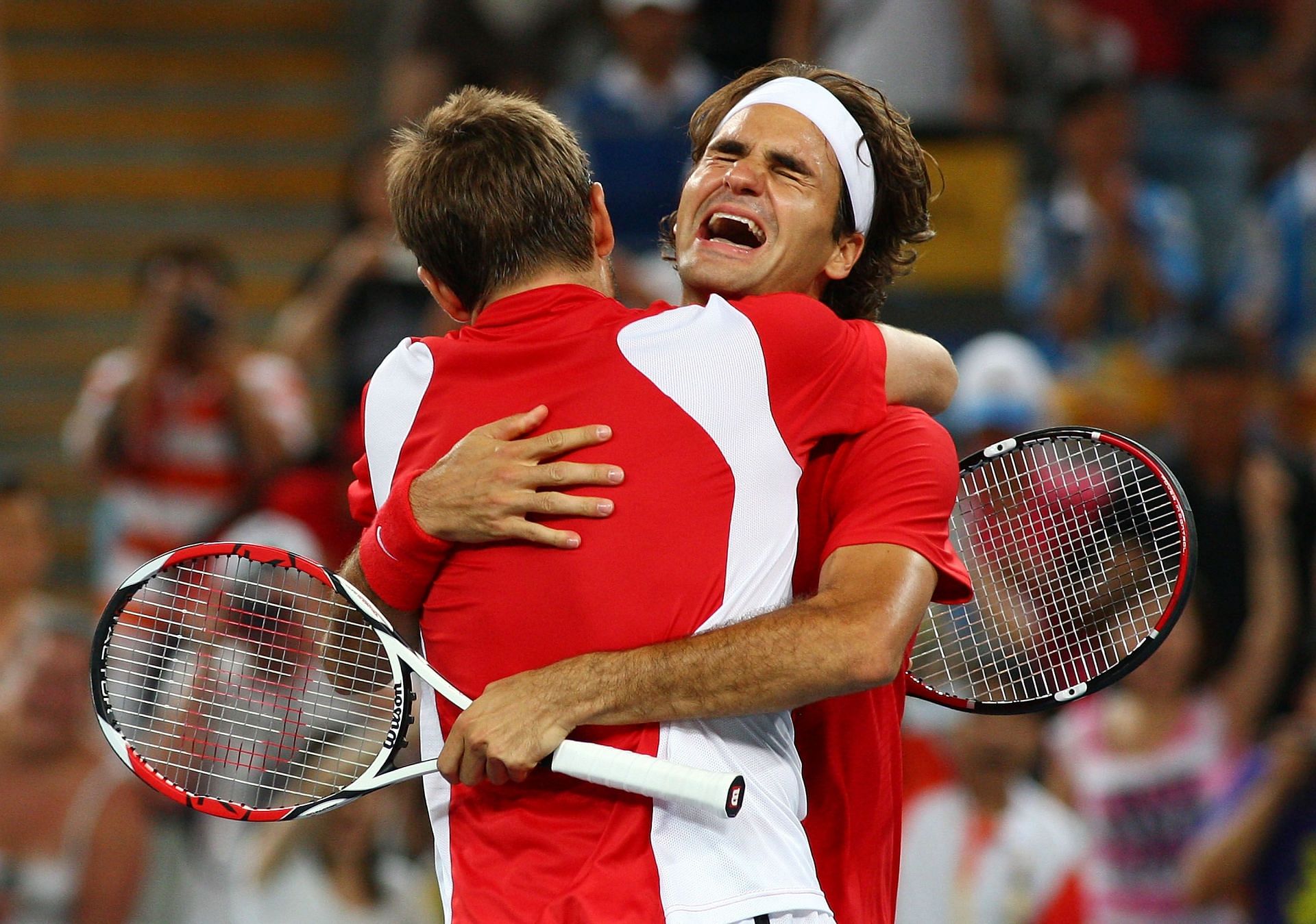 Roger Federer (right) hugs doubles partner Stan Wawrinka (left) after winning his only gold medal in the Olympics in 2008.