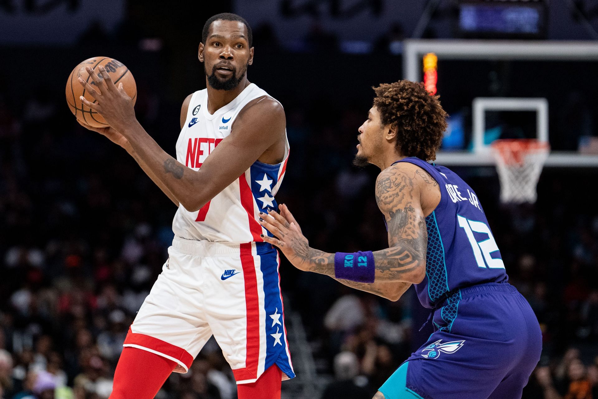 Kelly Oubre Jr. of the Charlotte Hornets guards Kevin Durant of the Brooklyn Nets