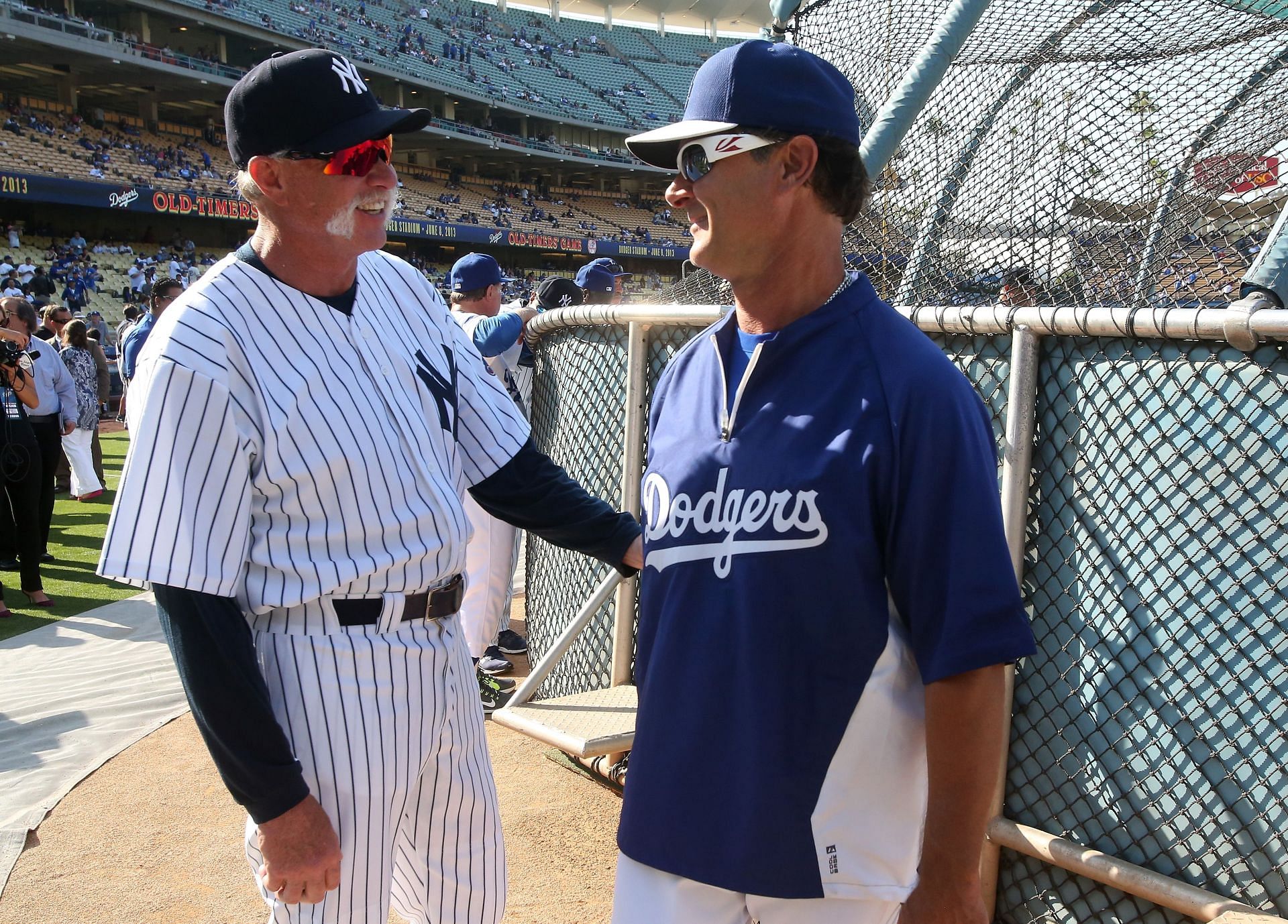 Former Yankees Rich Goose Gossage (L) and Don Mattingly, who is currently the Los Angeles Dodgers manager, talk before an Old Timers game