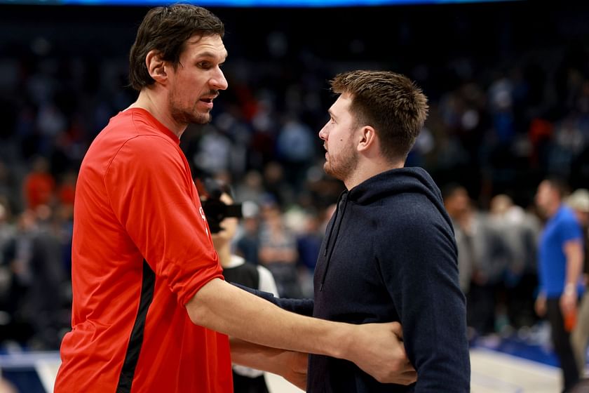 Dallas Mavericks' Boban Marjanovic shakes hands with a fan prior