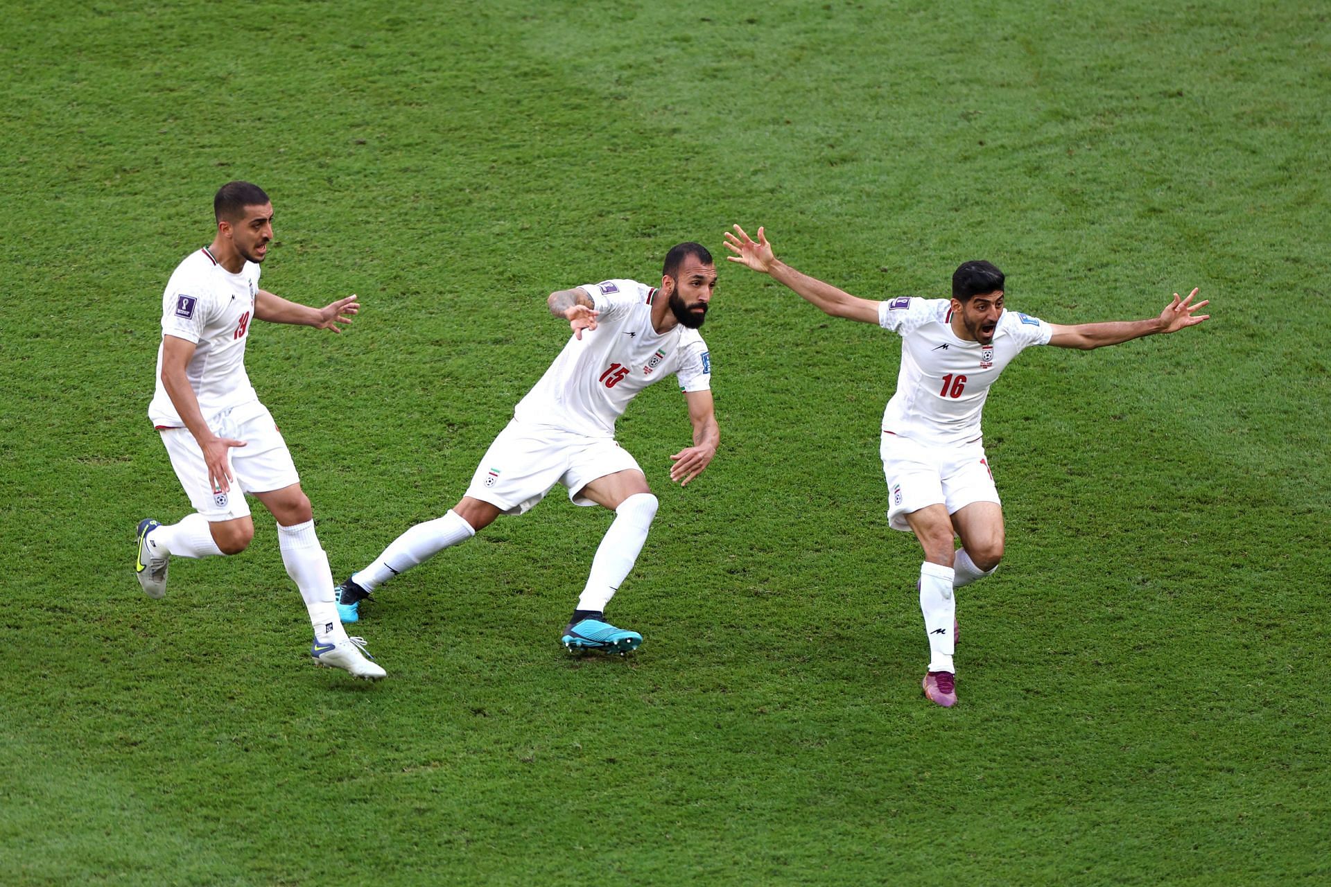 Roozbeh Cheshmi (C) celebrates after giving Iran the lead against Wales.