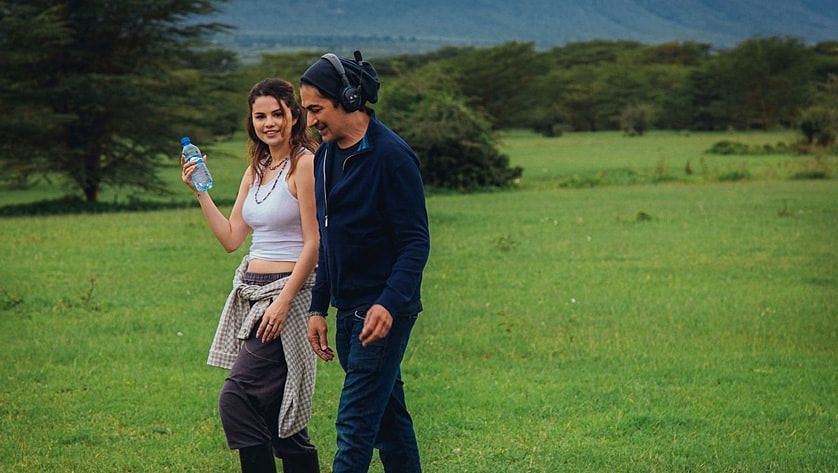 Selena Gomez with filmmaker Alek Keshishian discussing a scene of Selena Gomez: My Mind &amp; Me. (Image via Apple.com)