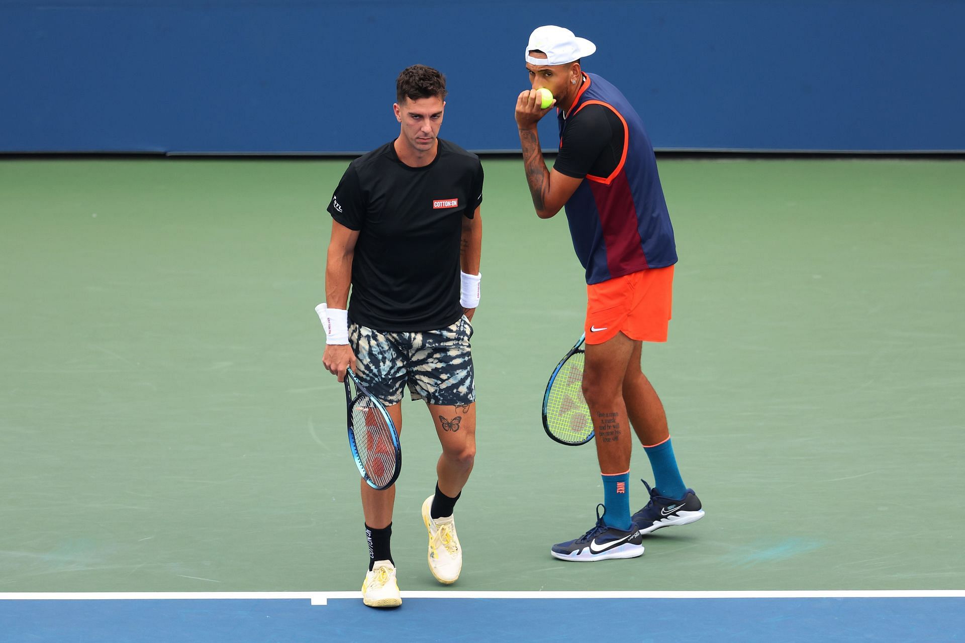 Thanasi Kokkinakis (L) and Nick Kyrgios in action at the 2022 US Open