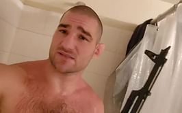 "Certified schizophrenic" - Fans react to Sean Strickland showering with an AK-47 gun in latest video