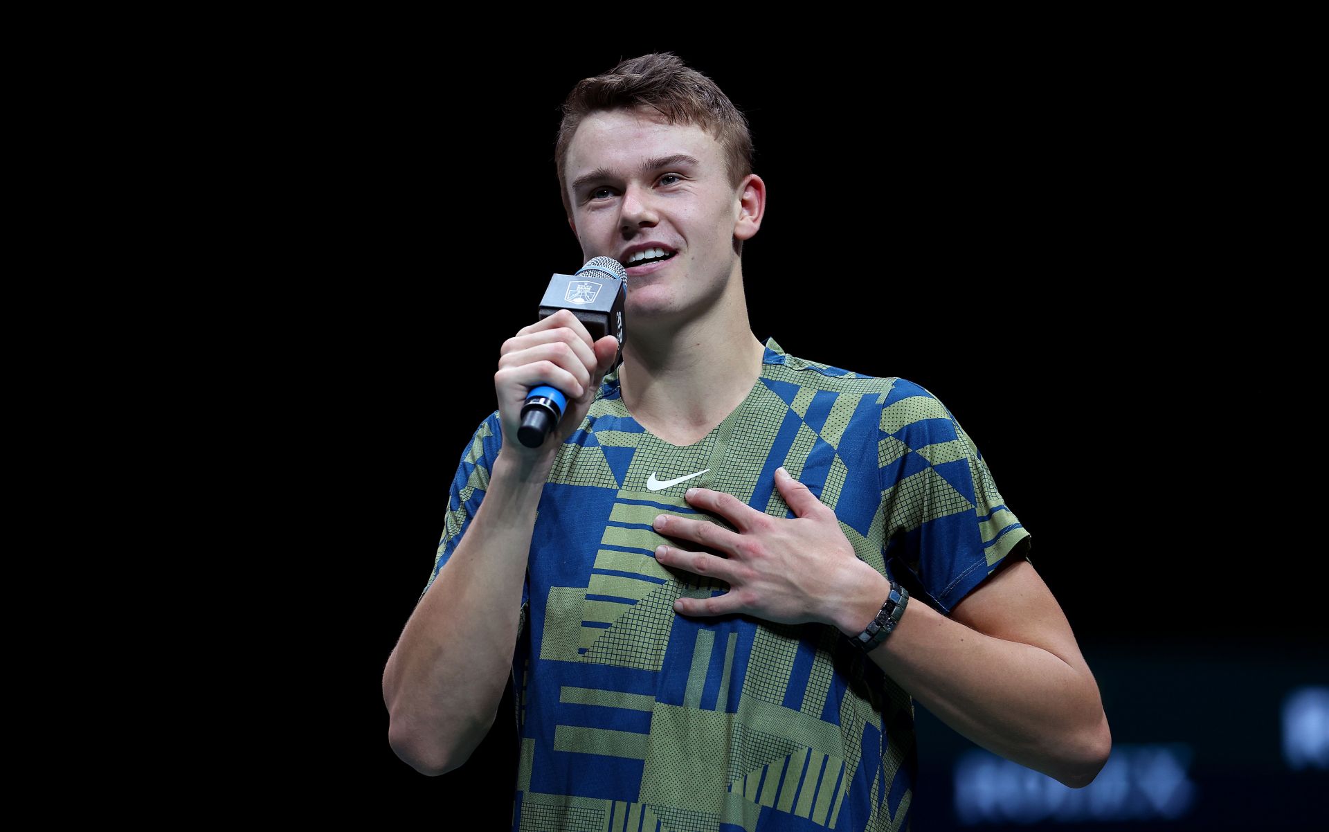 Holger Rune talks to the crowd after his win over Novak Djokovic at the Rolex Paris Masters