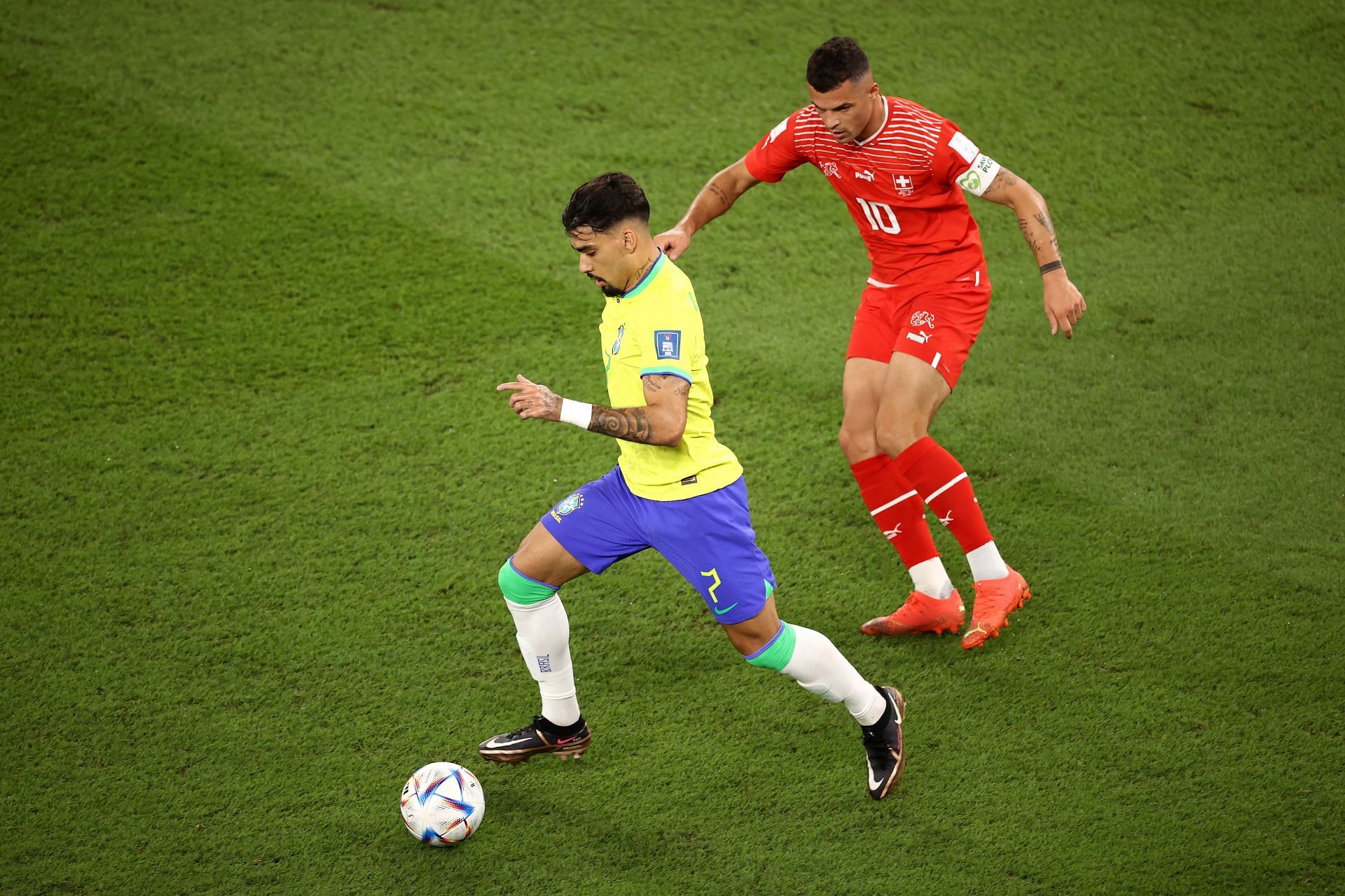 Lucas Paqueta controls the ball under pressure from Granit Xhaka.