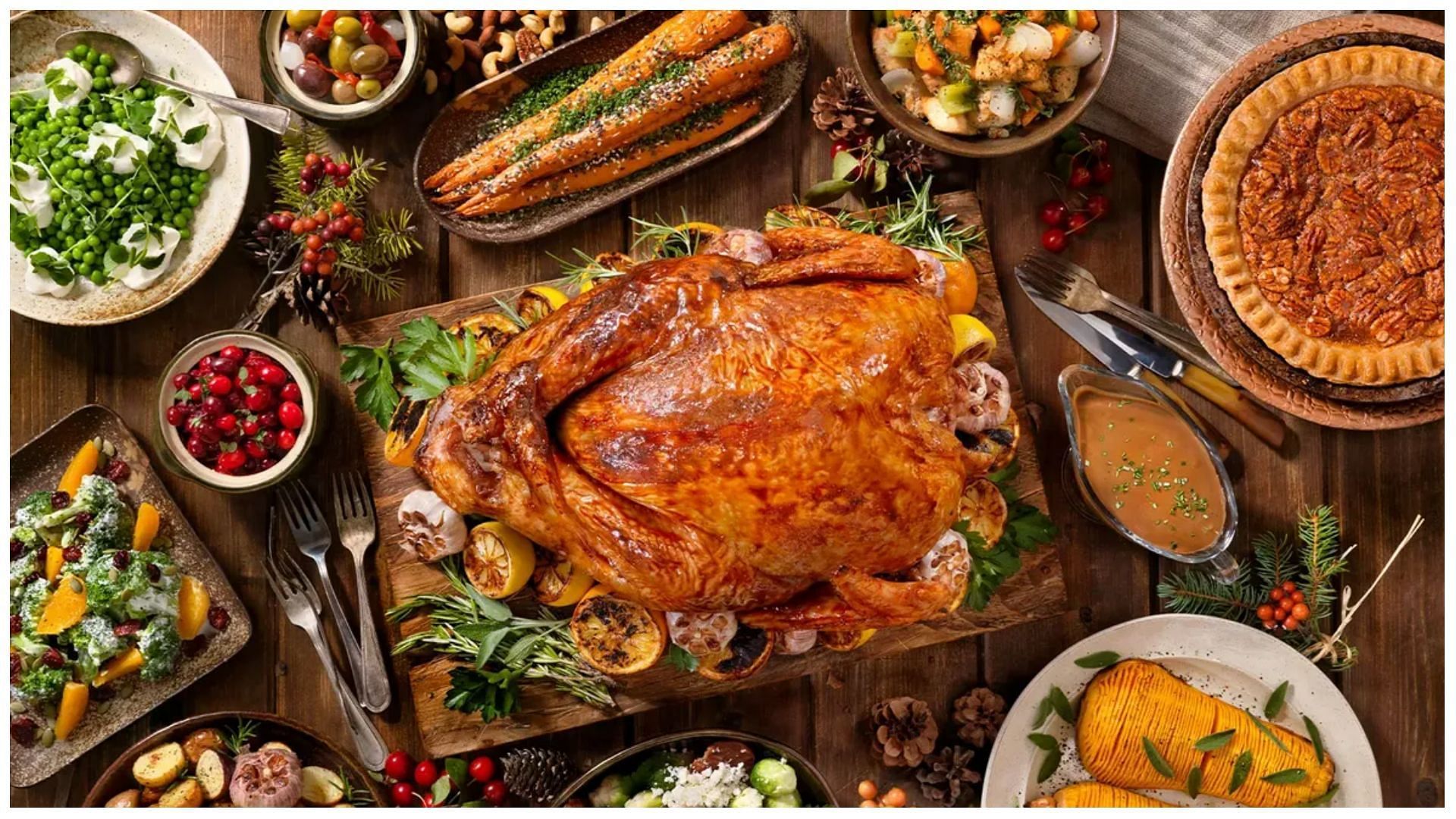 thanksgiving platter with smoked turkey, pumpking pie, and other holiday delicacies (Image via GettyImages)