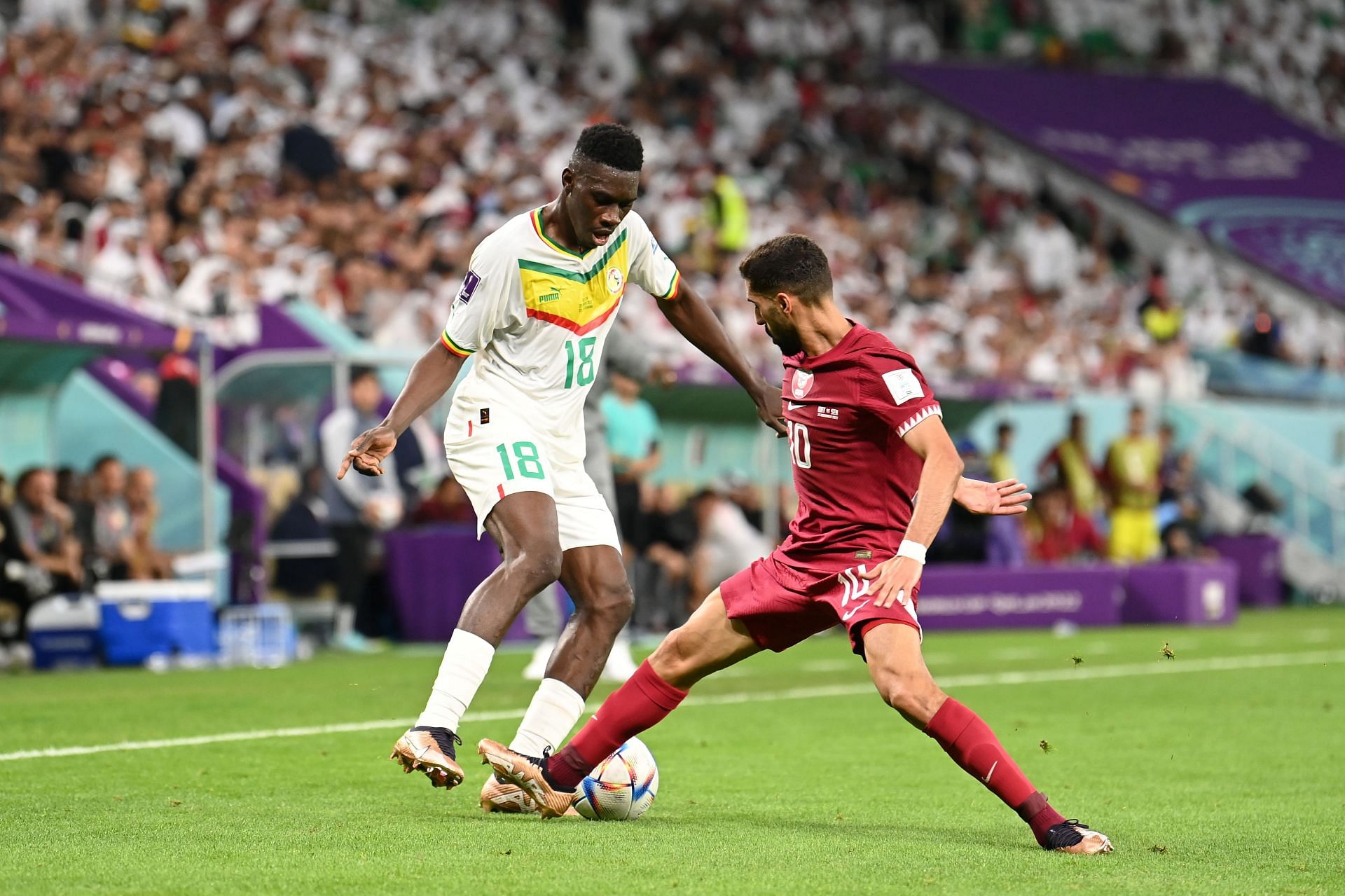 Ismaila Sarr takes on Hassan Alhaydos at Al Thumama Stadium in Qatar.