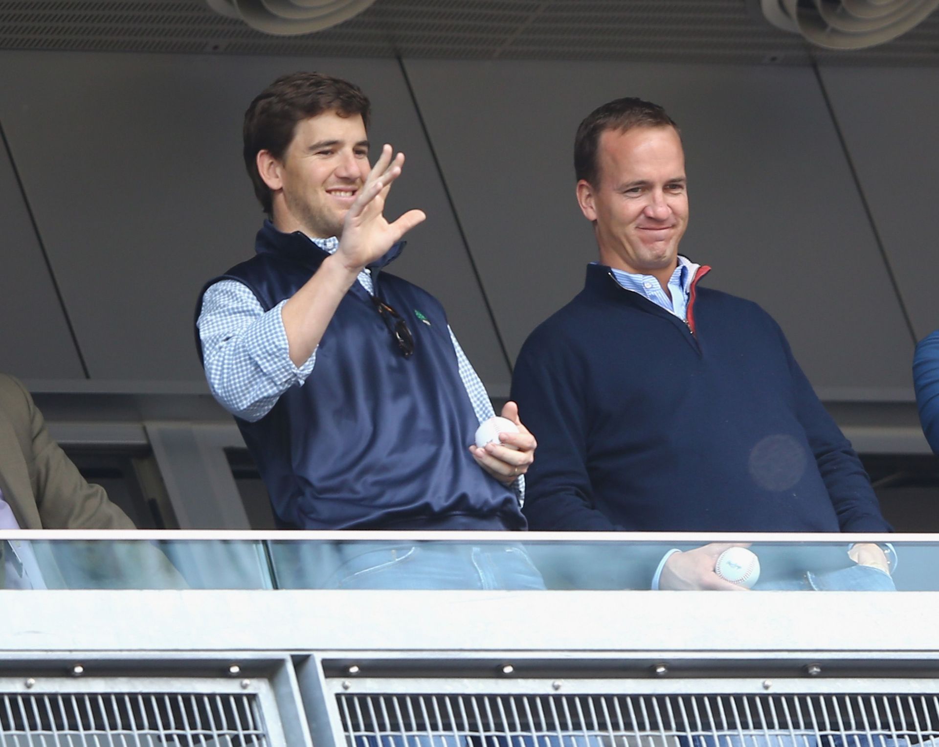 Eli Manning looks far from impressed as brother Peyton wins Super