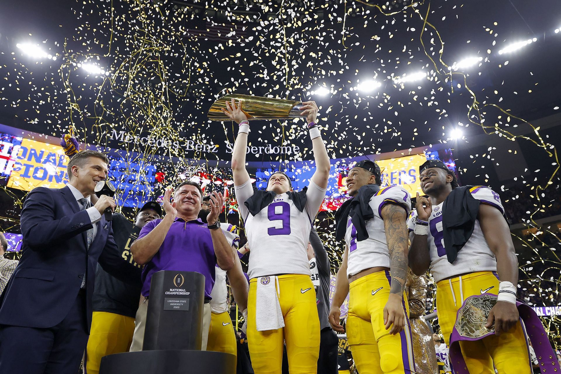 Joe Burrow celebrates winning the College Football Playoff National Championship with his LSU coaches and teammates
