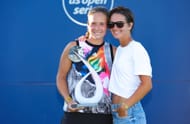 Olympic figure skater Natalia Zabiiakoi joins champion Daria Kasatkina on the court during the trophy ceremony in San Jose
