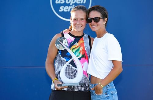 Olympic figure skater Natalia Zabiiakoi joins champion Daria Kasatkina on the court during the trophy ceremony in San Jose