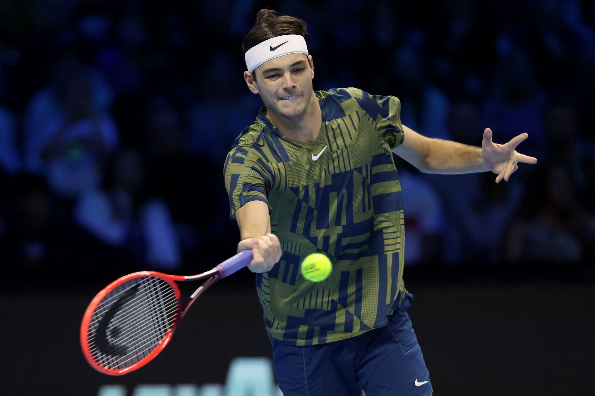 Taylor Fritz returns a shot to Rafael Nadal during their round-robin match at the Nitto ATP Finals