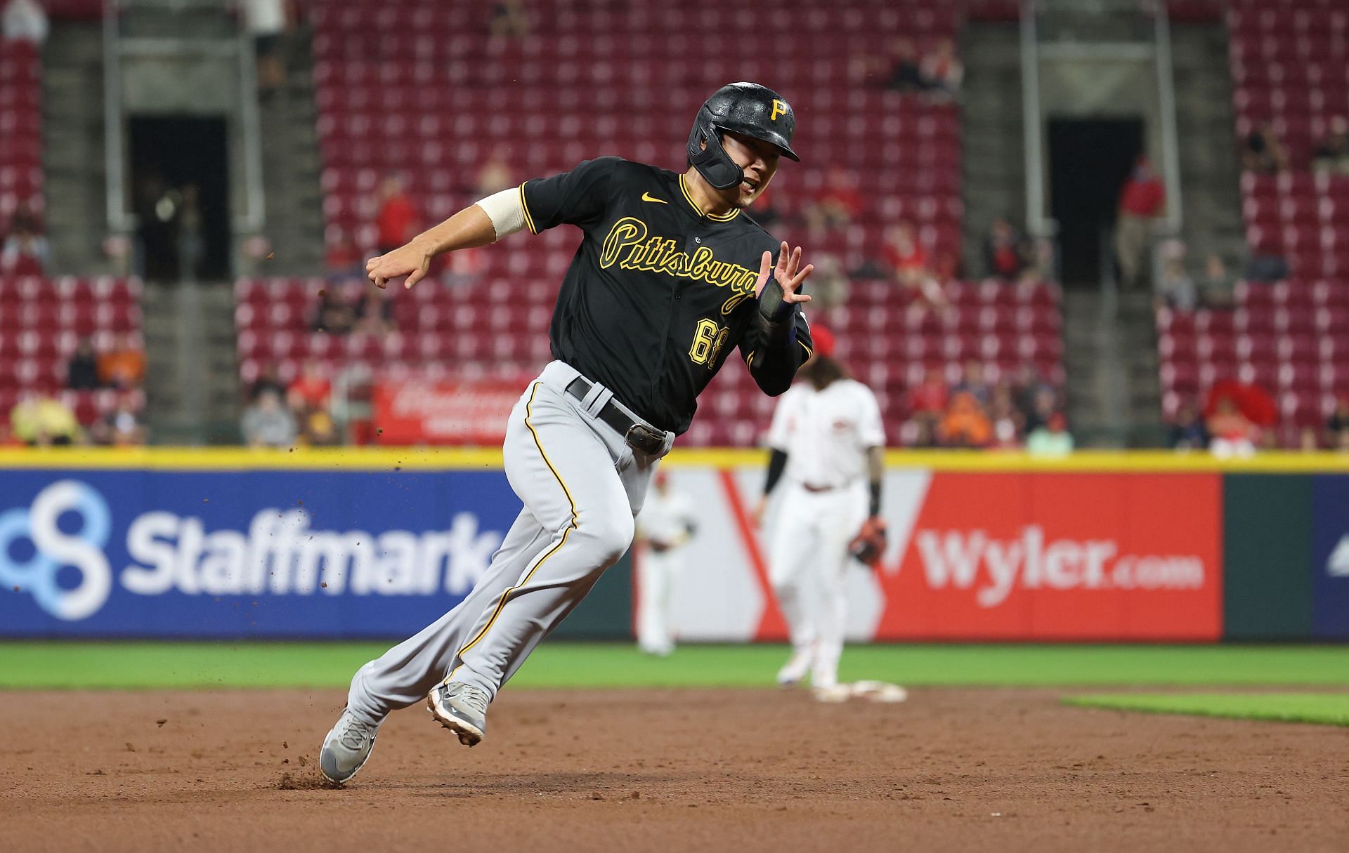 Hoy Park rounds third base on his way to score against the Cincinnati Reds at Great American Ball Park.