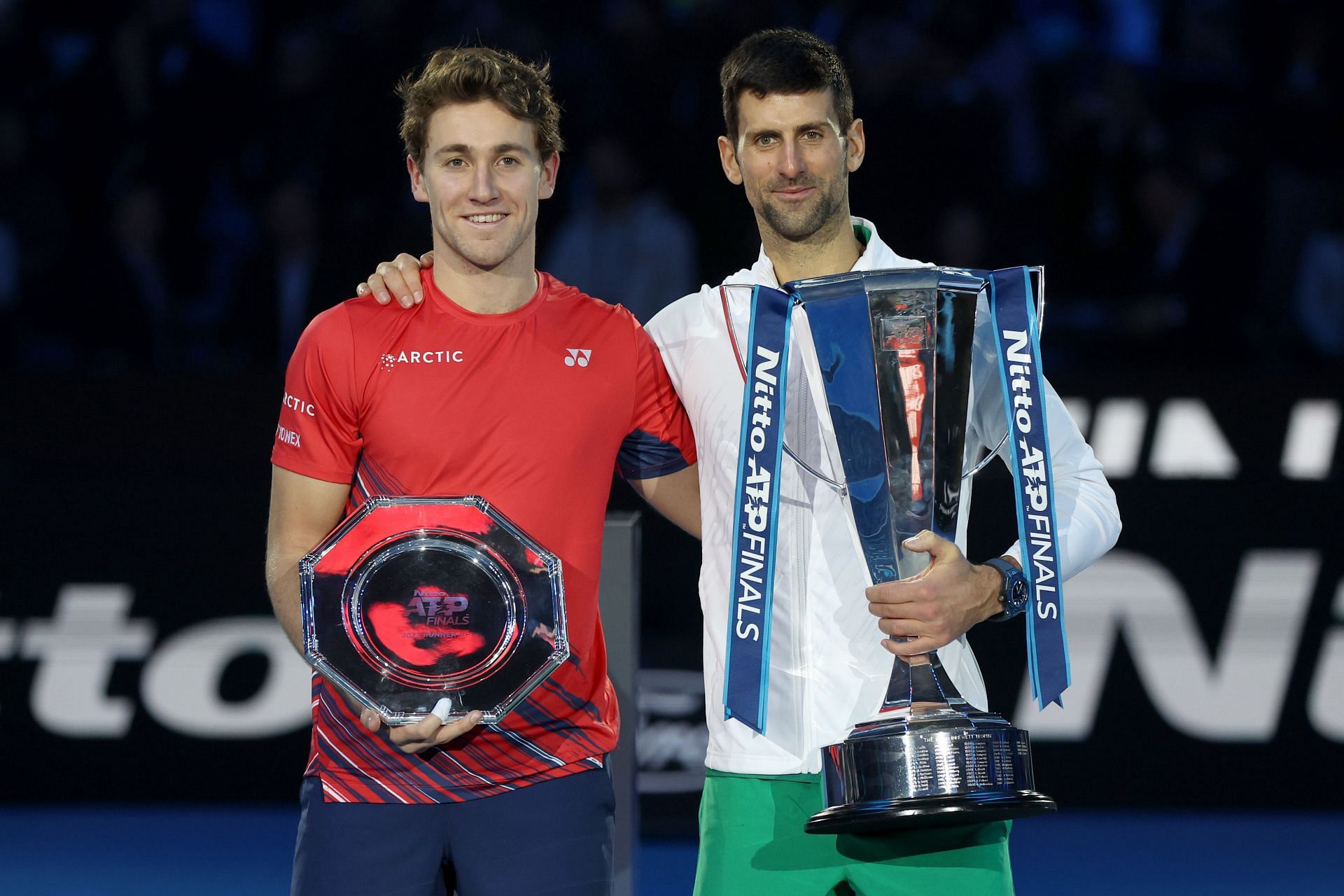 Casper Ruud and Novak Djokovic pose with their trophies at the 2022 ATP Finals