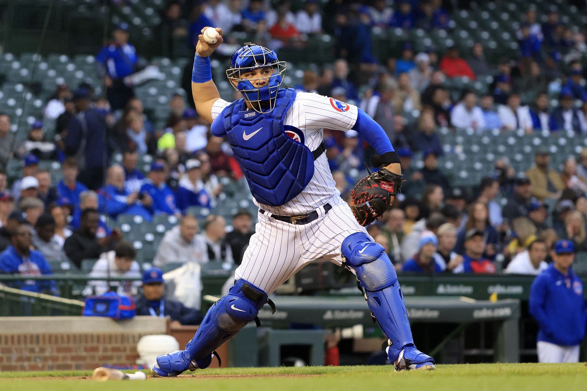 Willson Contreras throws the ball to first base in the game against the Pittsburgh Pirates at Wrigley Field