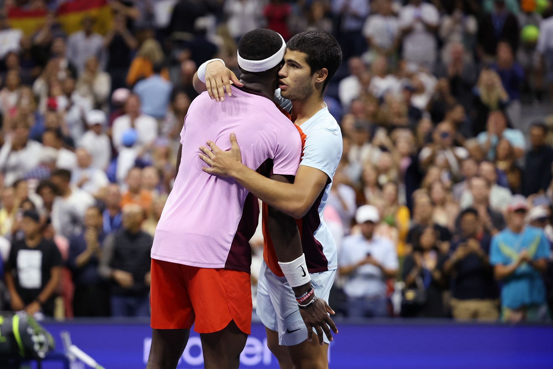 Frances Tiafoe and Carlos Alcaraz pictured hugging at the 2022 US Open.
