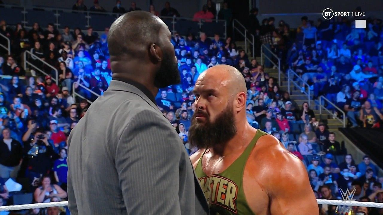 Omos towering over Braun Strowman on WWE SmackDown