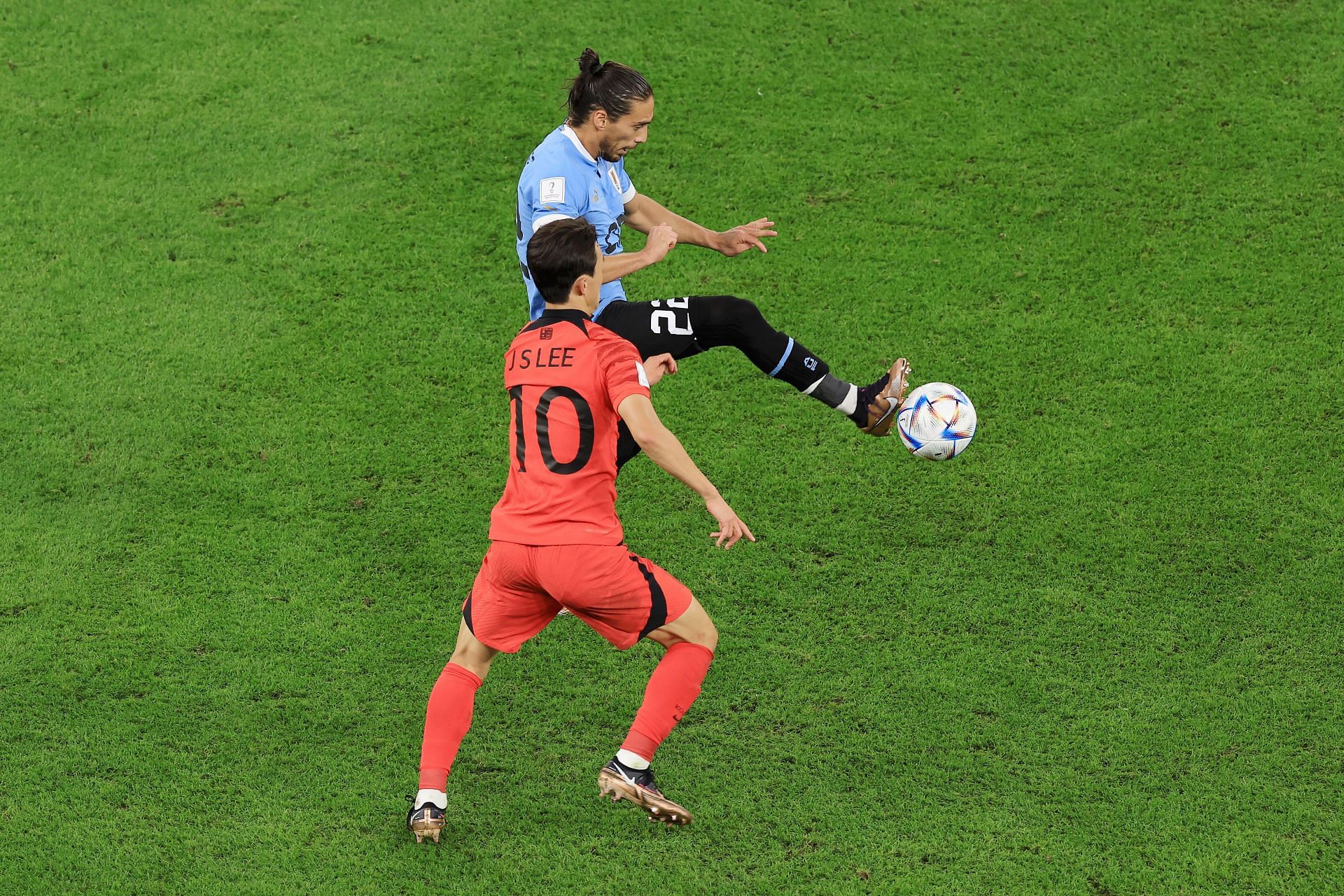 Martin Caceres controls the ball under pressure from Jaesung Lee.