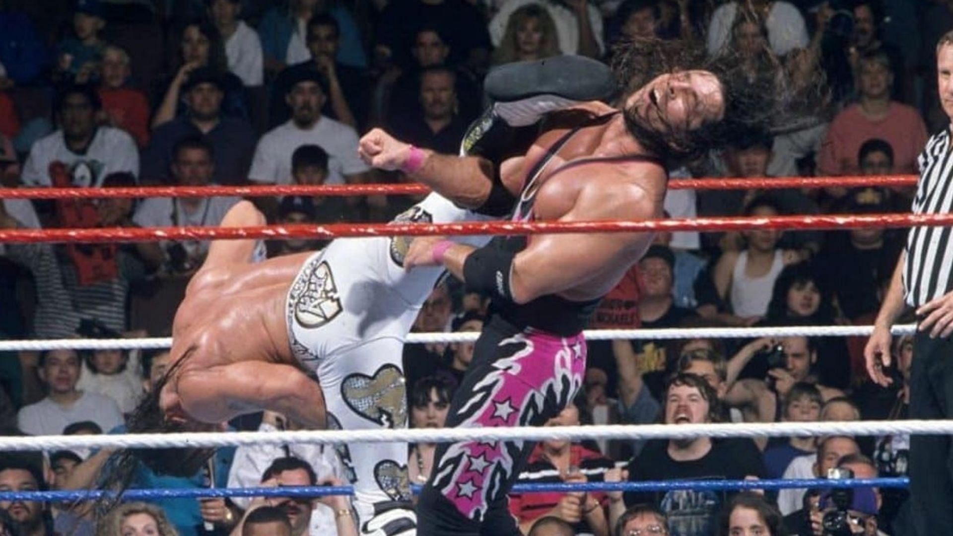 Shawn Michaels landing the Sweet Chin Music on Bret Hart.