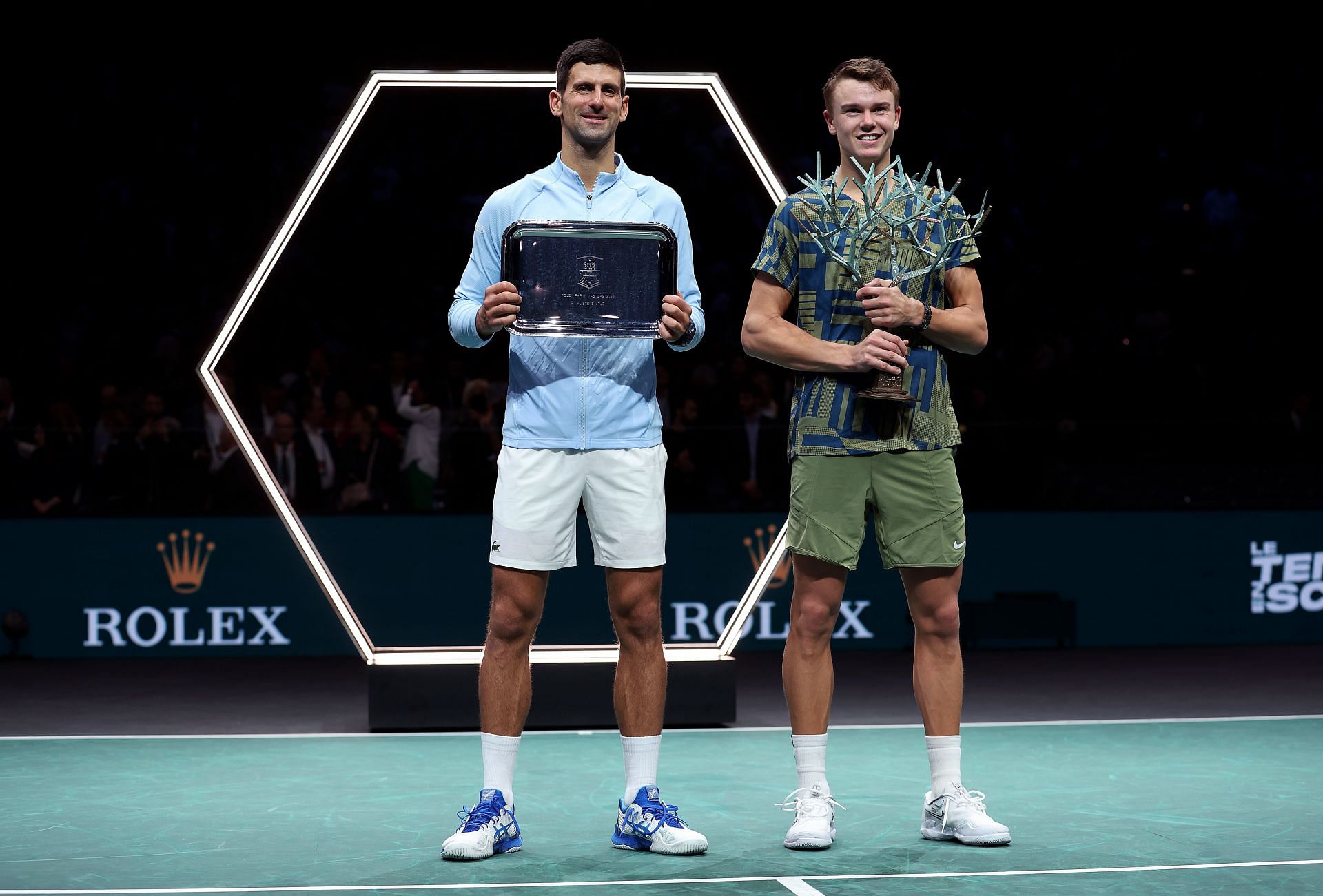 Novak Djokovic [left] and Holger Rune with their respective Paris Masters trophies