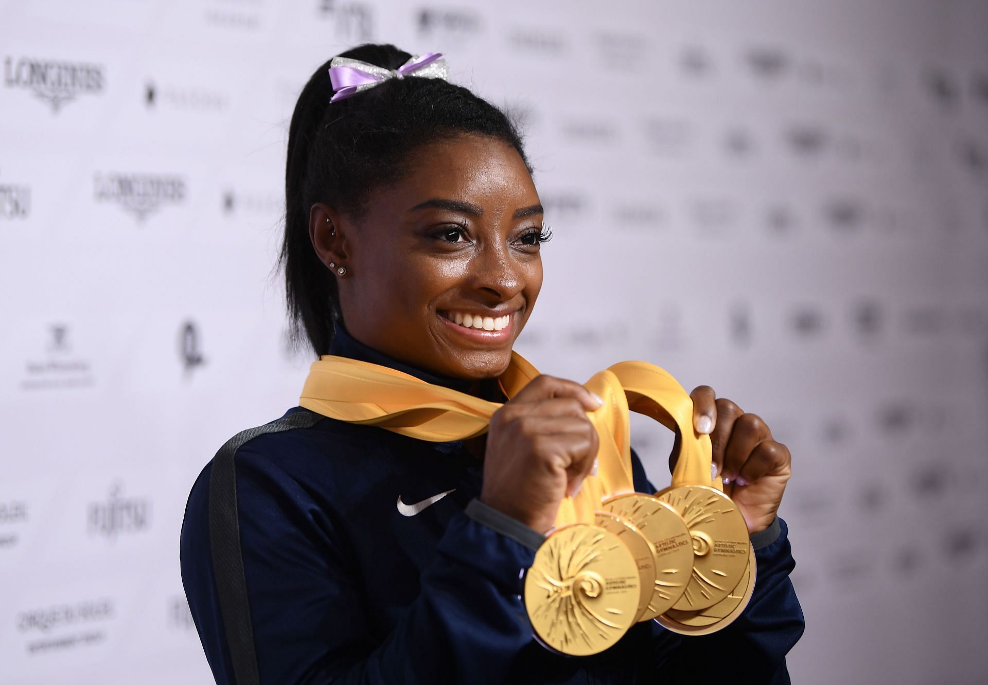 Simone Biles poses with the medals she won at the 2019 World Championships