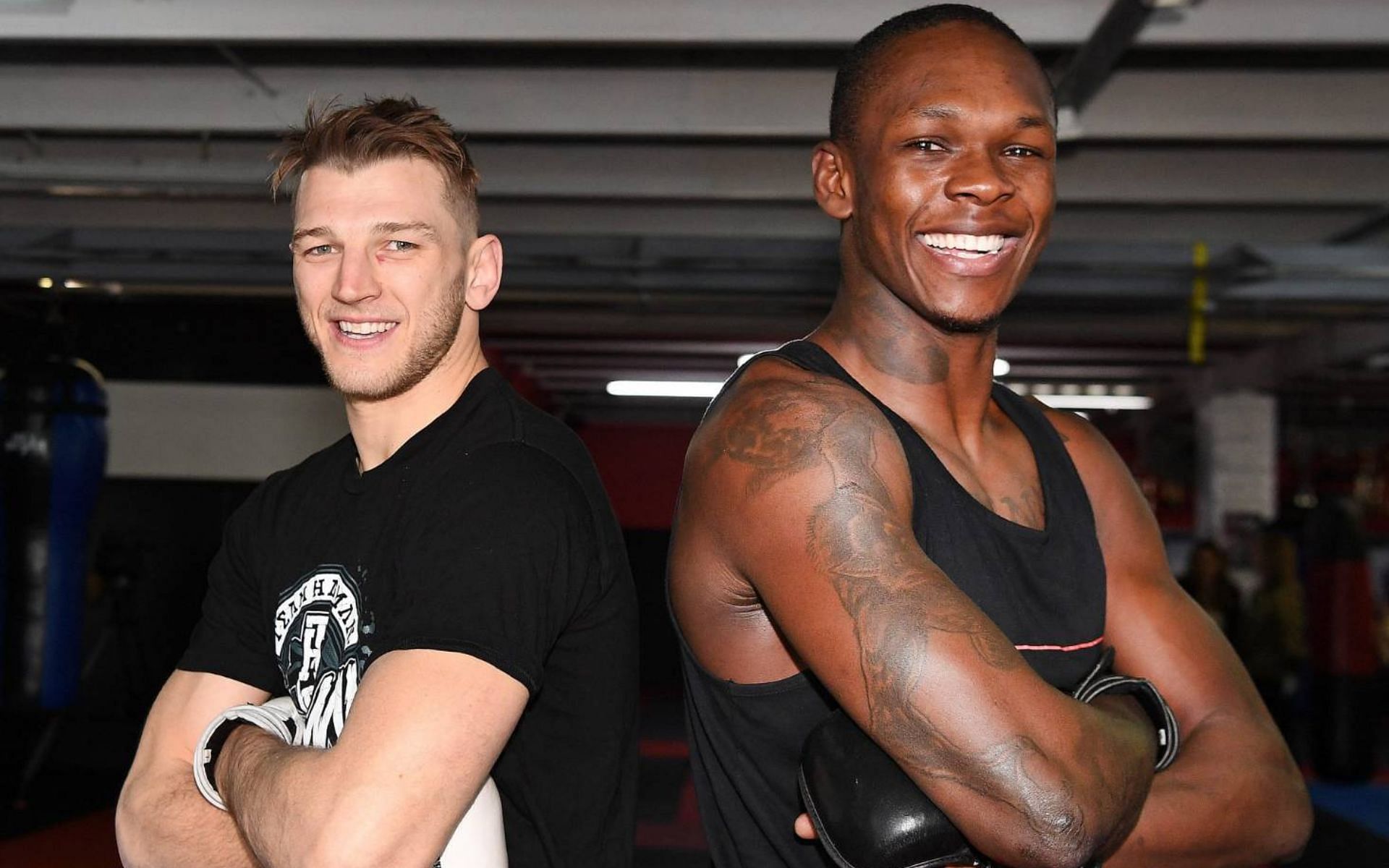 Dan Hooker (left) and Israel Adesanya (right). [Image courtesy: Andrew Cornaga/PHOTOSPORT]