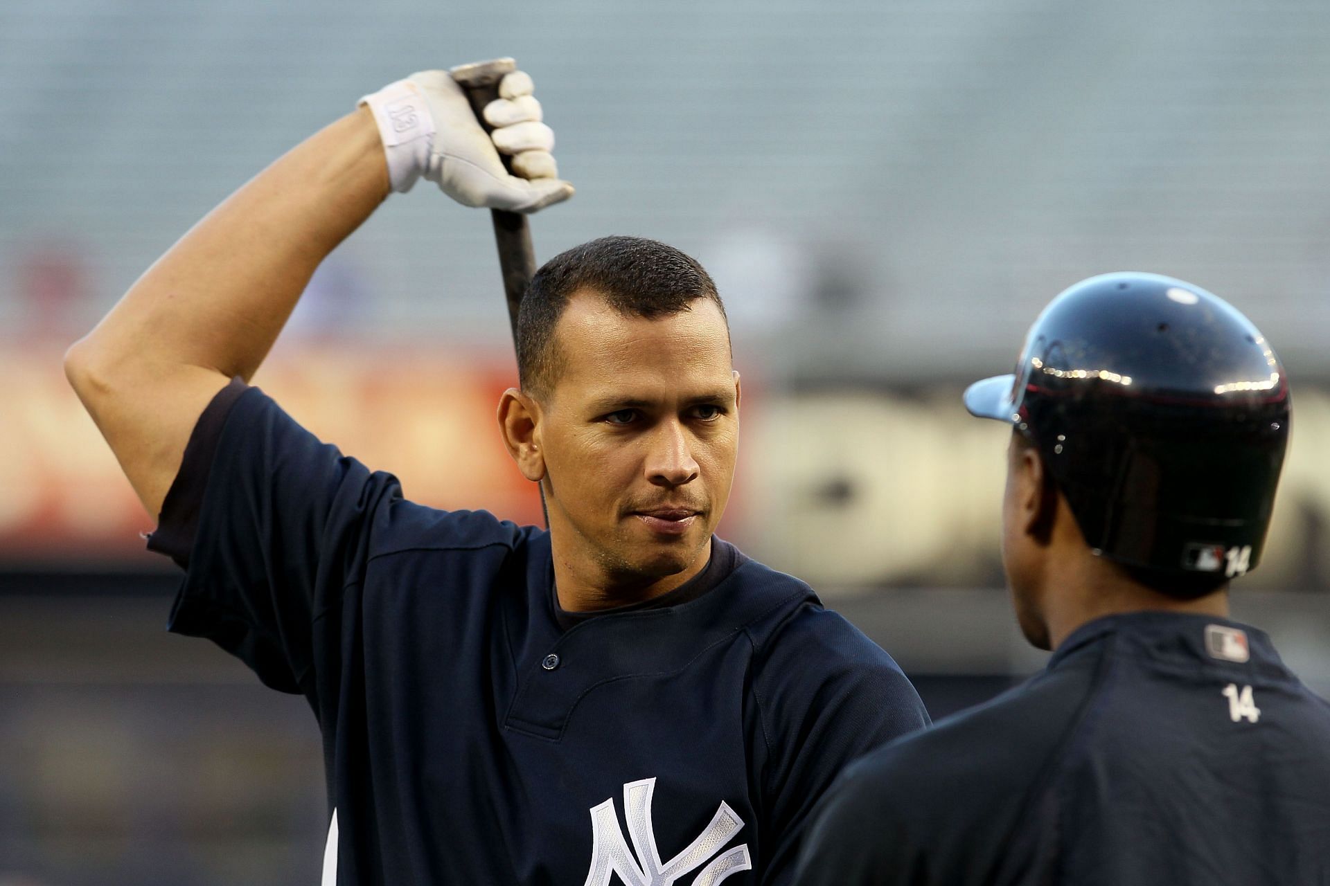 Alex Rodriguez #13 of the New York Yankees talks with Curtis Granderson #14 during batting practice against the Minnesota Twins during Game Three of the ALDS part of the 2010 MLB Playoffs at Yankee Stadium on October 9, 2010 in the Bronx borough of New York City