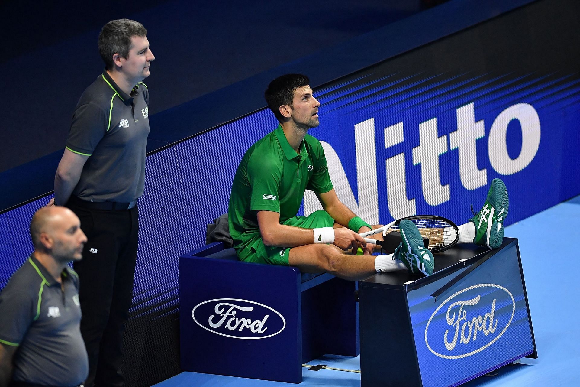 Novak Djokovic sits on the line judge&#039;s chair during his round-robin match against Daniil Medvedev in the ATP Finals.