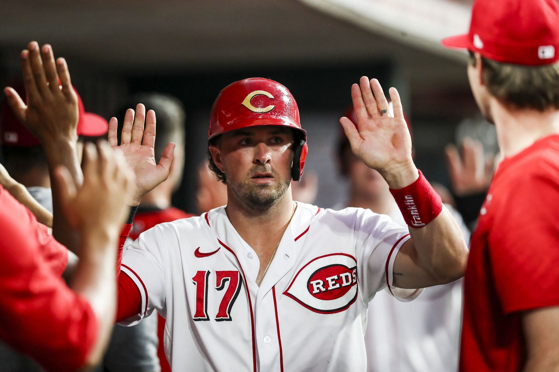 Kyle Farmer high fives his teammates after scoring in the sixth inning at Great American Ball Park