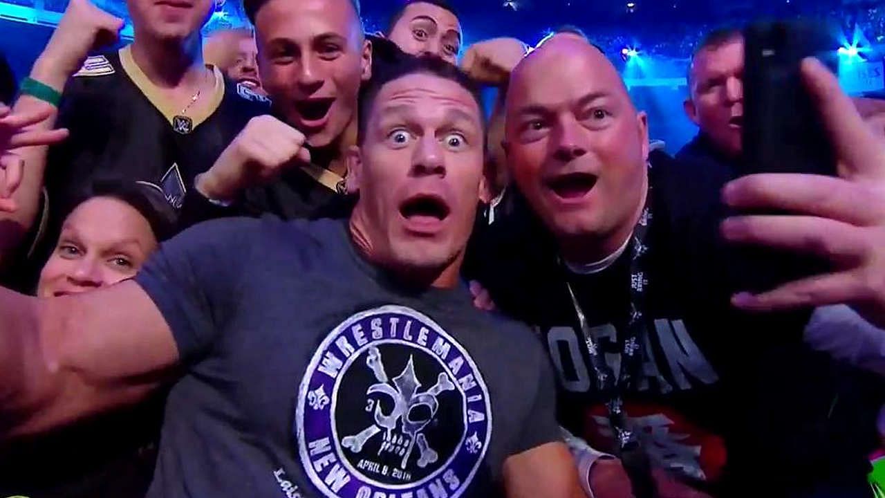 Cena taking photos with fans at WrestleMania 34