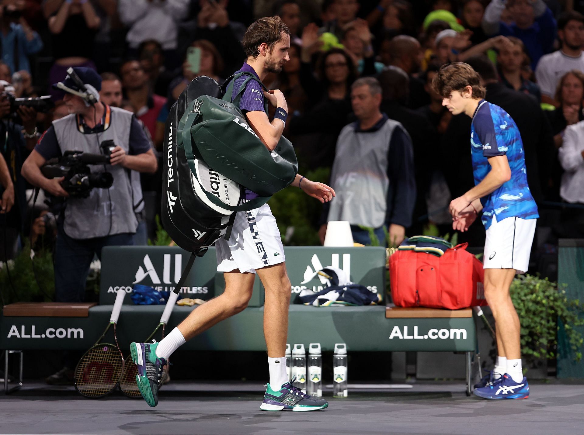 Daniil Medvedev [left] walks off the court after losing to Alex de Minaur at the 2022 Rolex Paris Masters