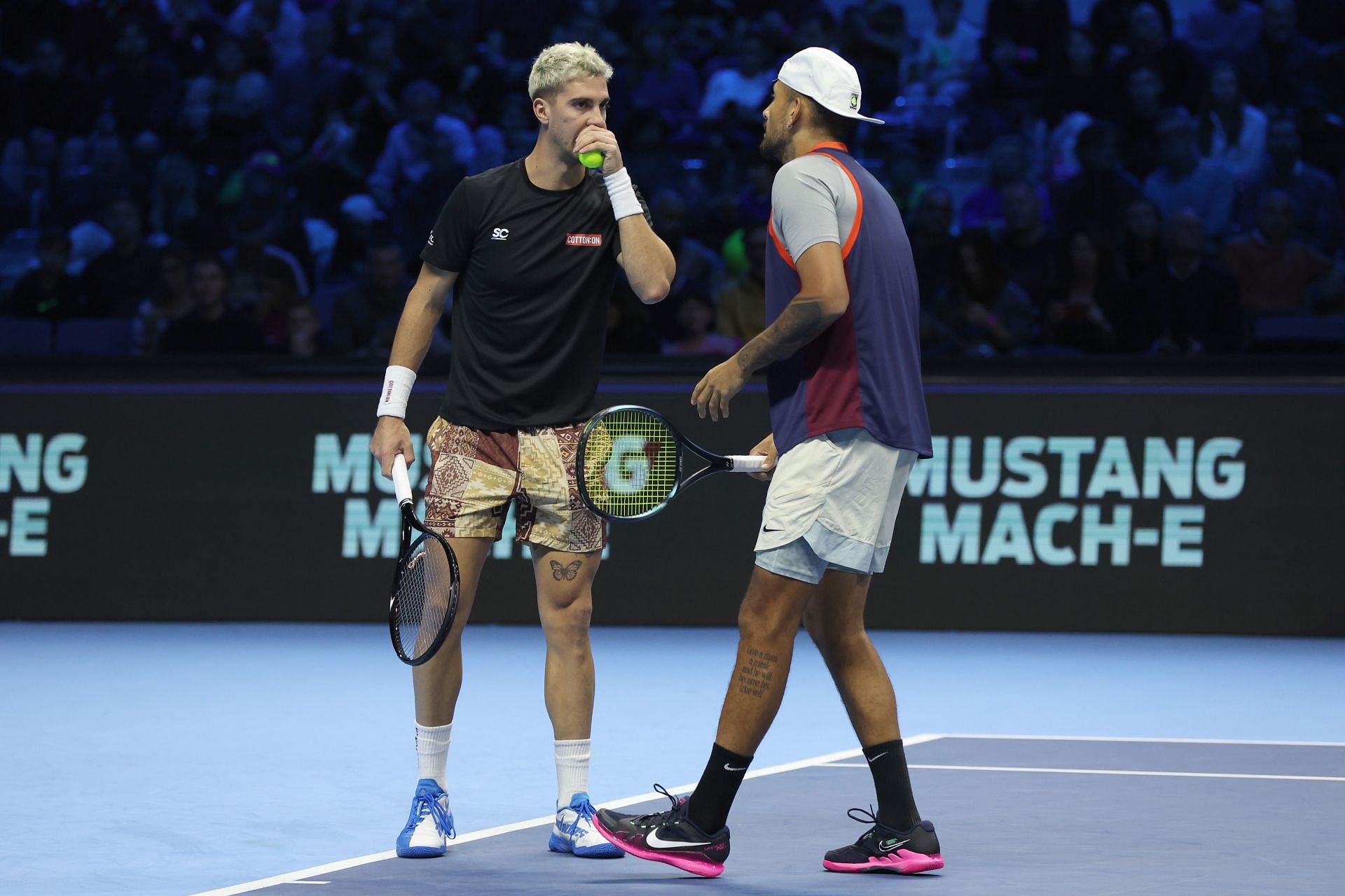 Thanasi Kokkinakis and Nick Kyrgios of Australia confer while playing Nikola Mektic and Mate Pavic at the 2022 ATP Finals