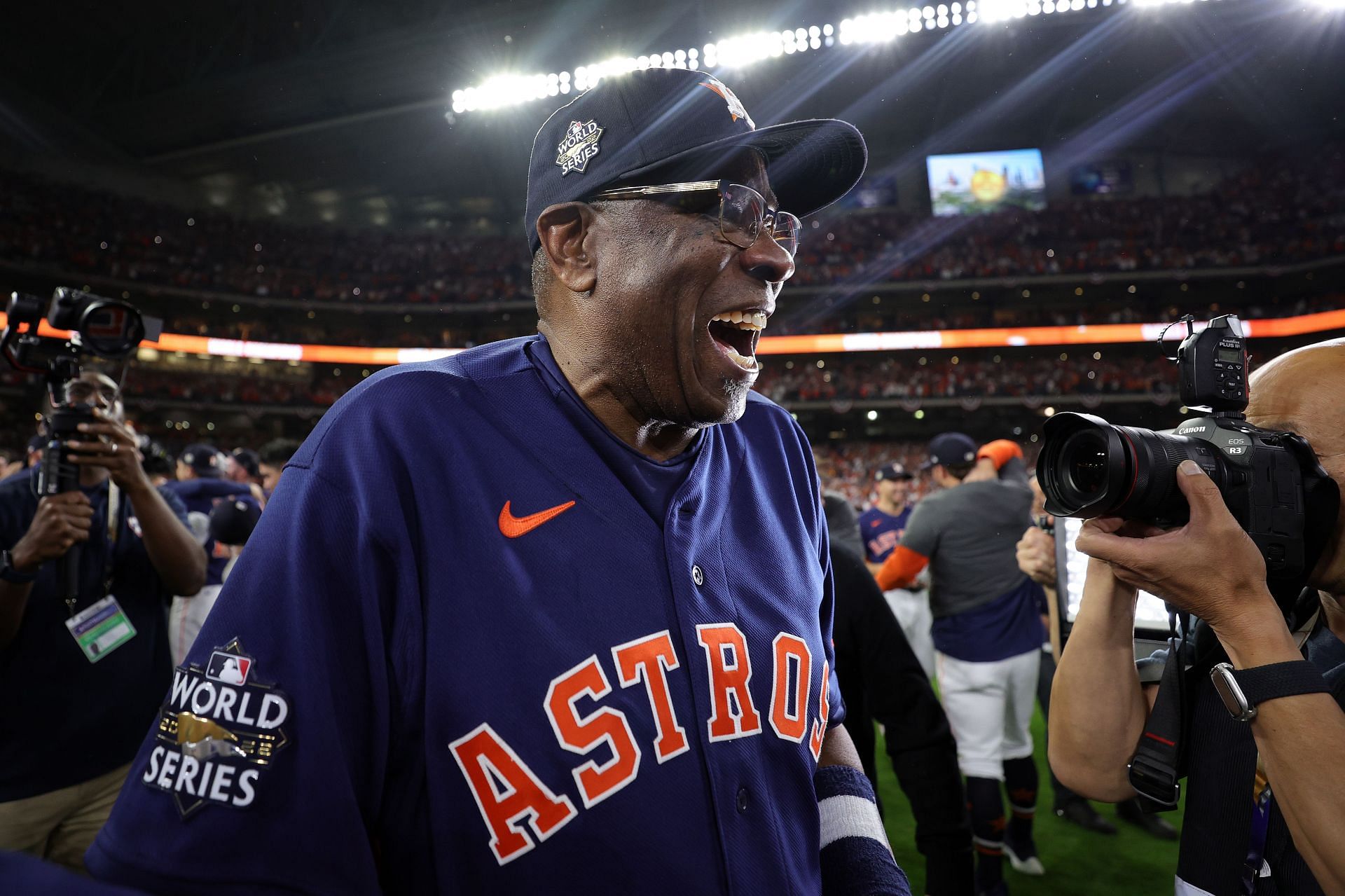 Houston Astros manager Dusty Baker Jr., left, shows his 2022 World Series  champions ring with Houston Astros owner Jim Crane, right, and Crane's  wife, Whitney Crane, during a ring presentation ceremony before